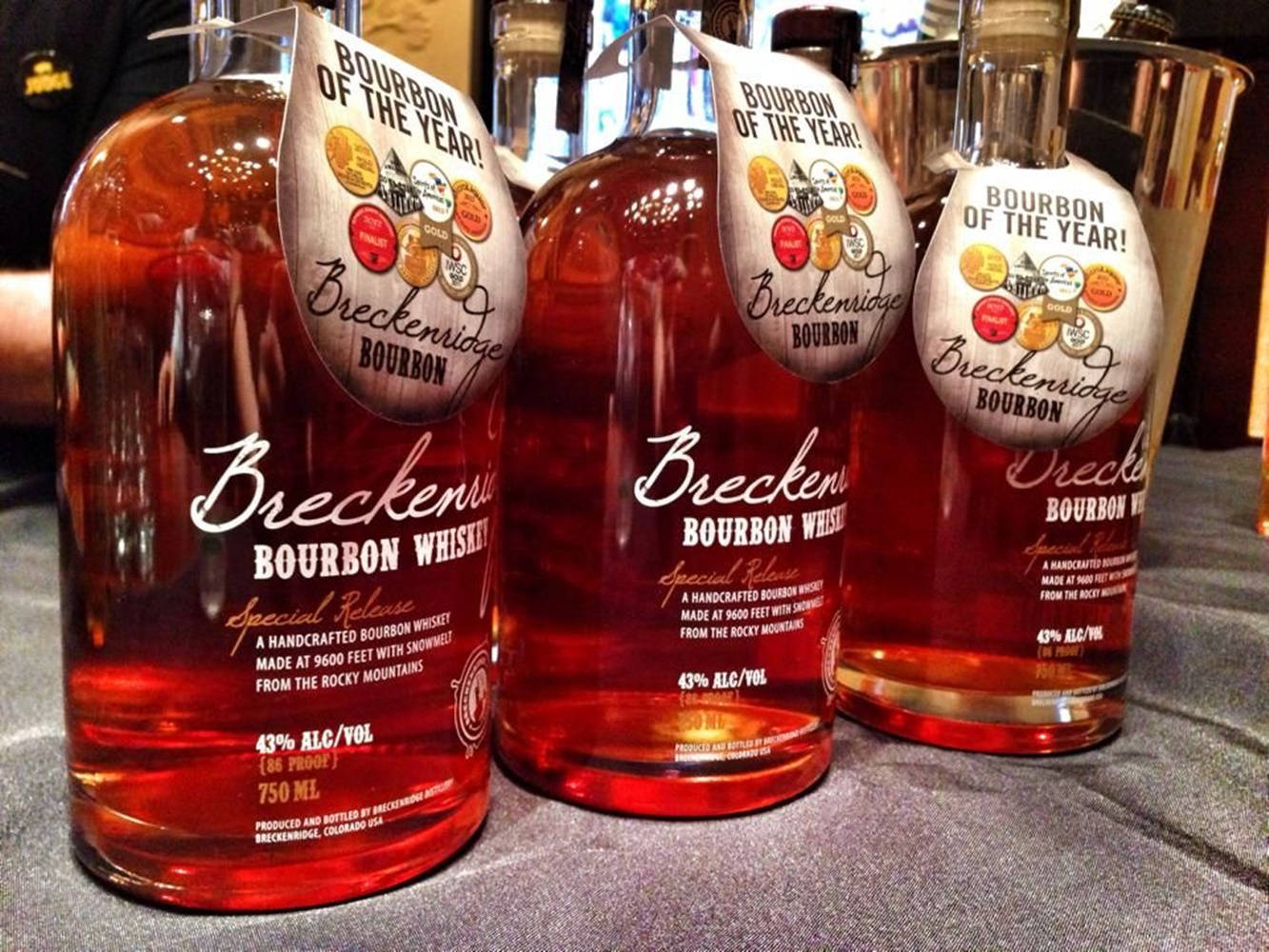 Caption: Award-winning Breckenridge Distillery Bourbon Bottle Showcased Against A Stunning Backdrop. Background