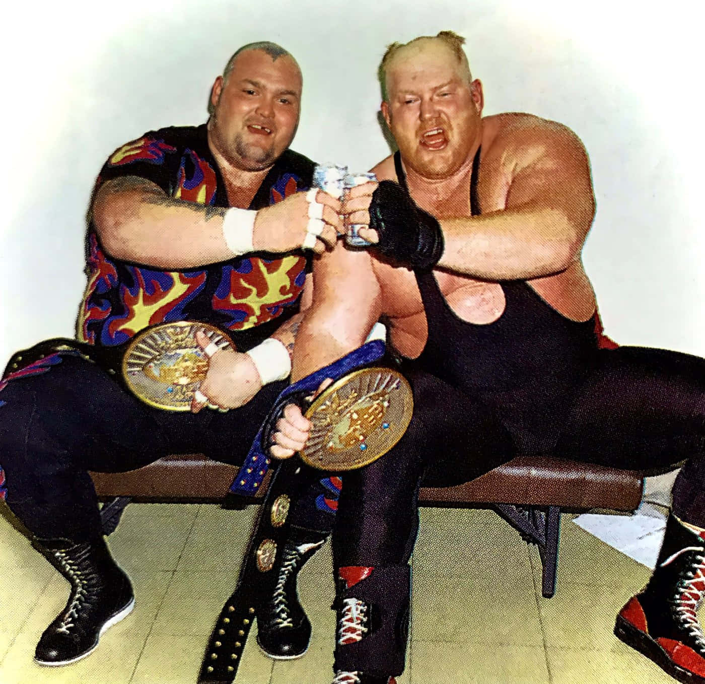 Caption: Bam Bam Bigelow And Big Van Vader Celebrating Victory Background