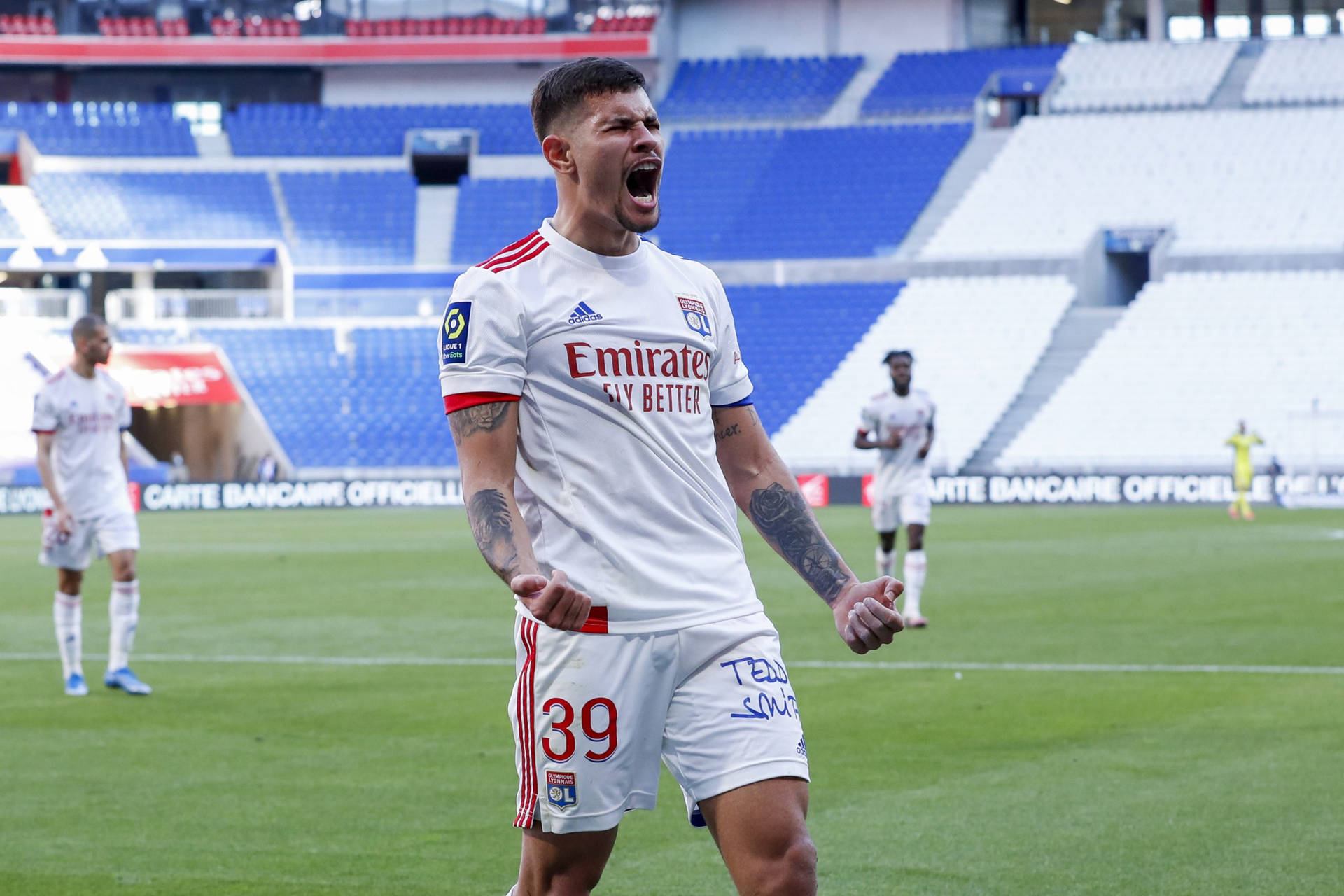 Caption: Bruno Guimarães In Action On The Football Field. Background