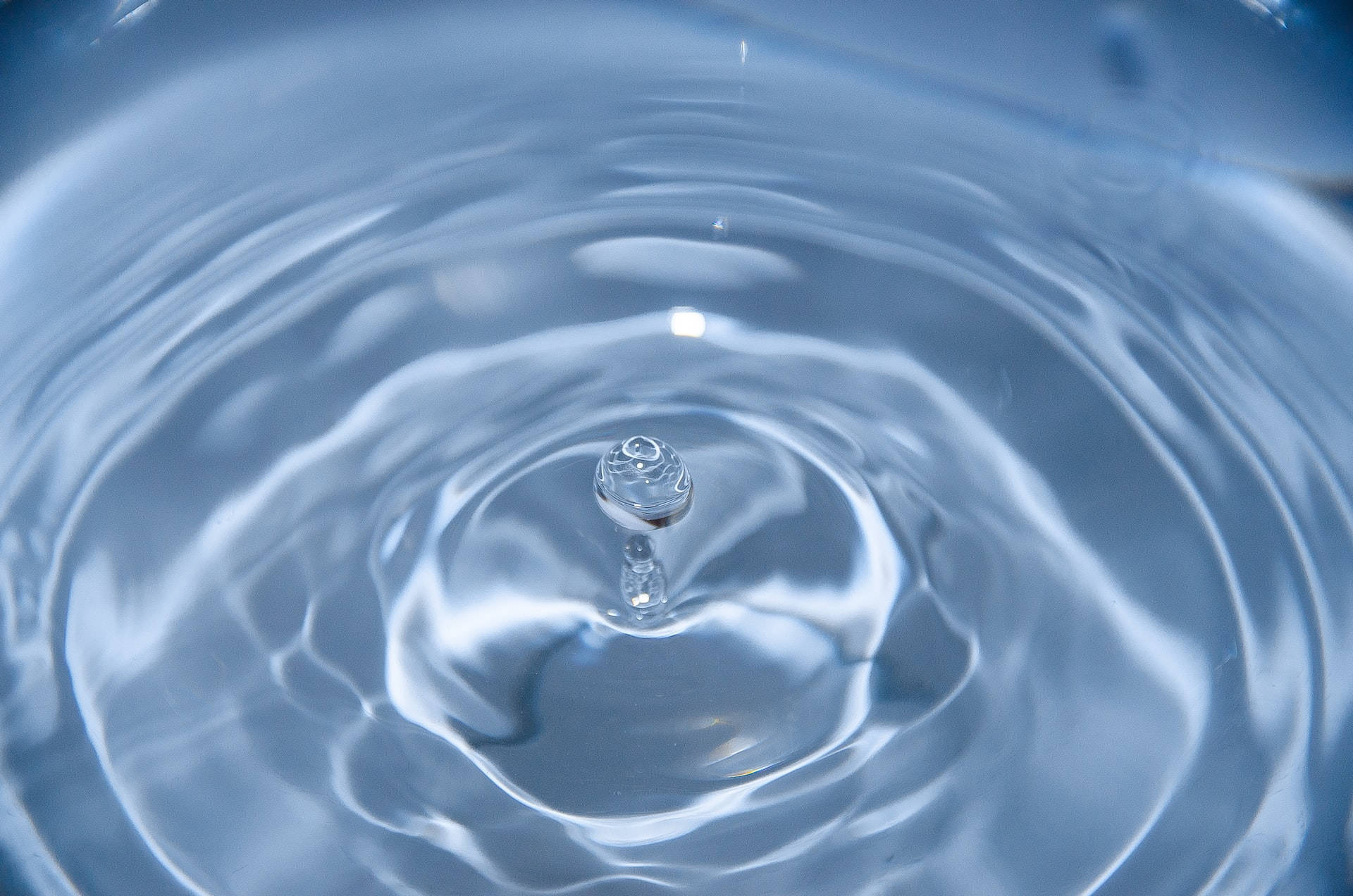 Caption: Calming Flow Of Water In Household Sink Background