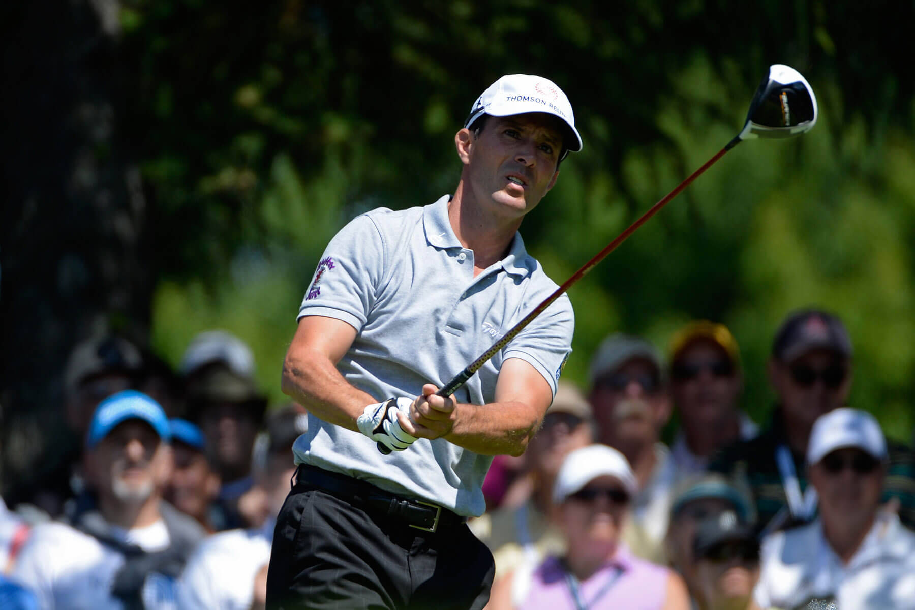 Caption: Canadian Golfer Mike Weir Swinging Under Sunny Skies Background