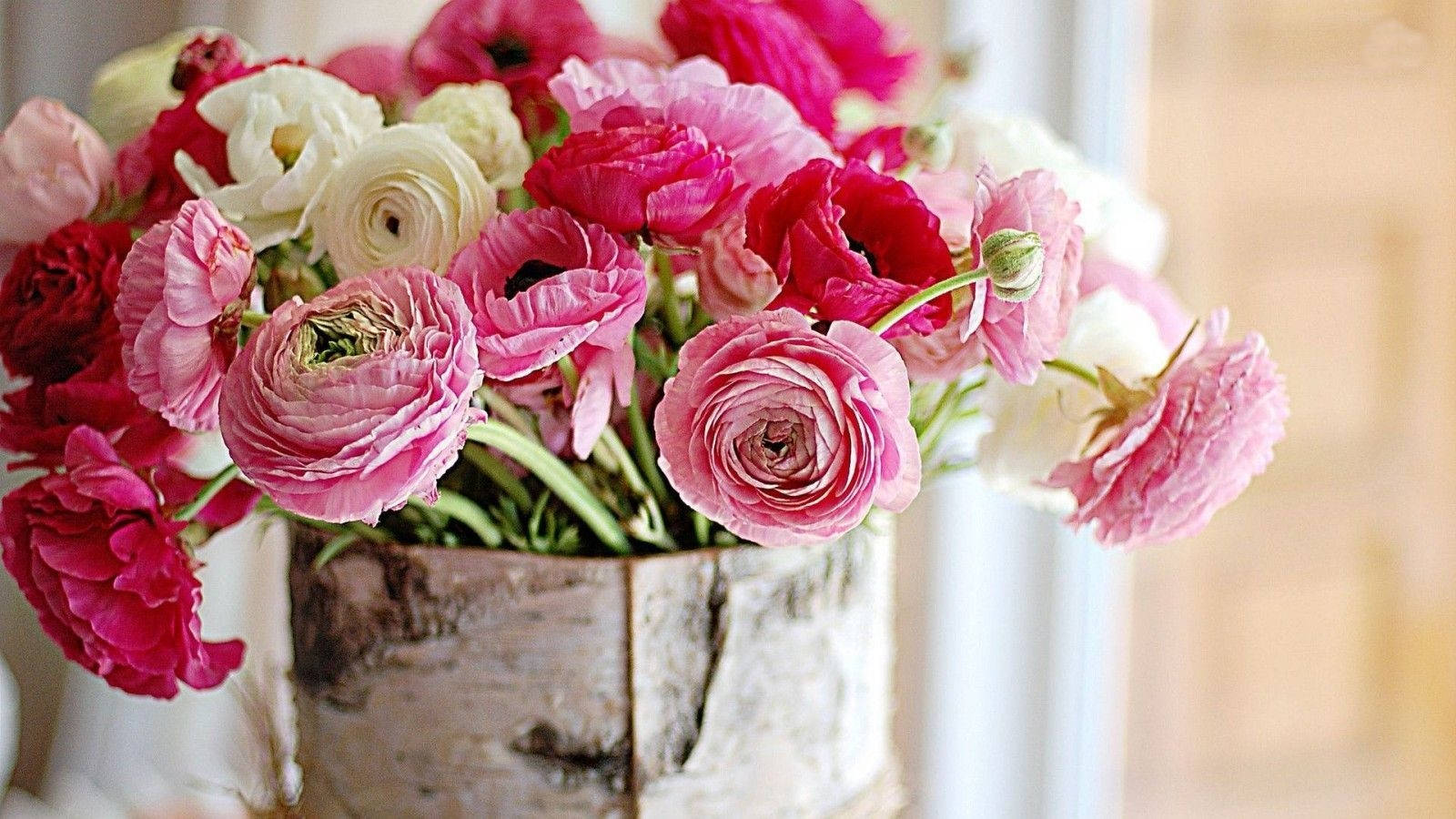 Caption: Captivating Bouquet Of Pink Roses In A Vintage Vase Background