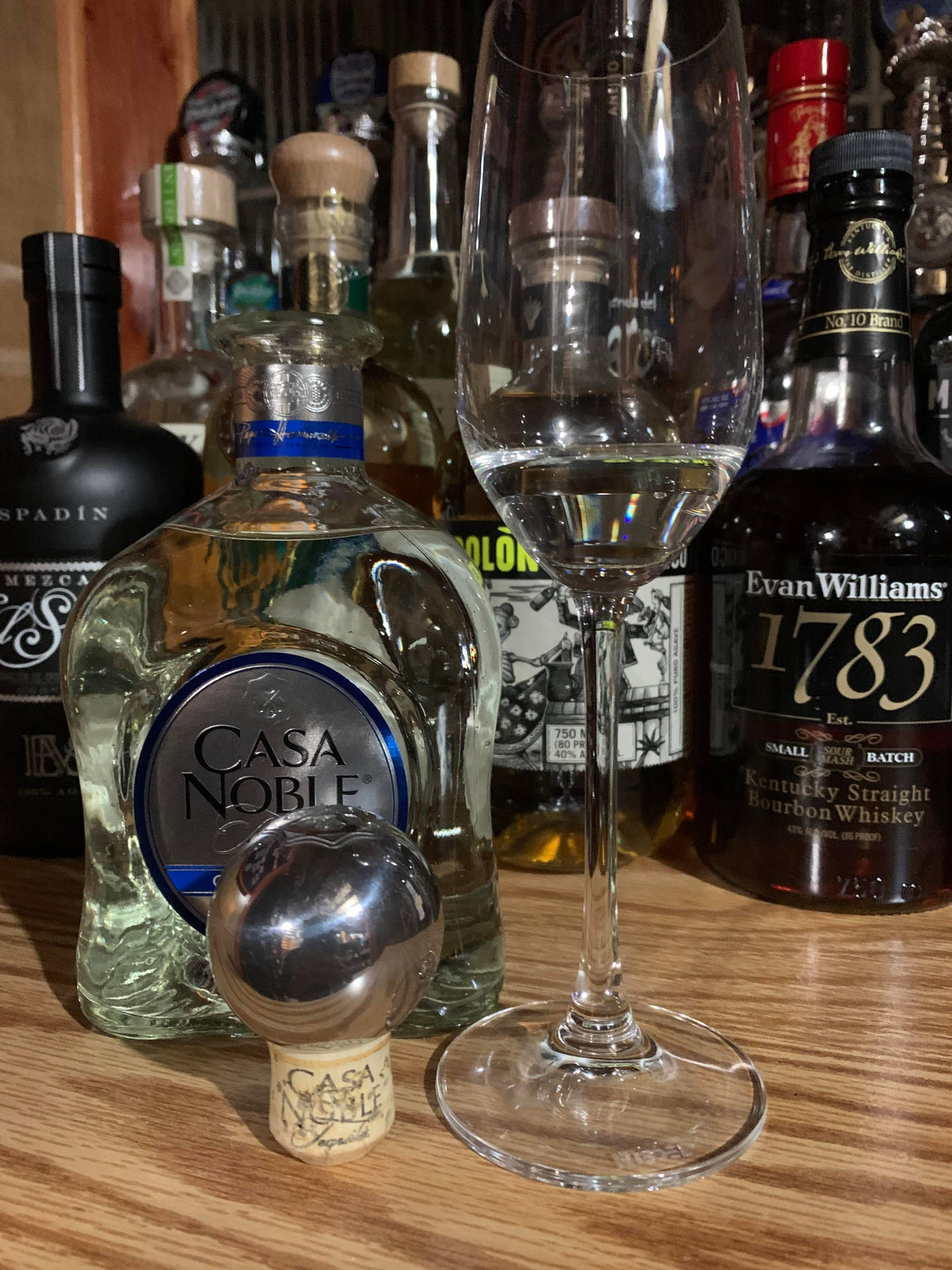 Caption: Casa Noble Crystal Blanco Tequila In An Elegant Champagne Glass Background