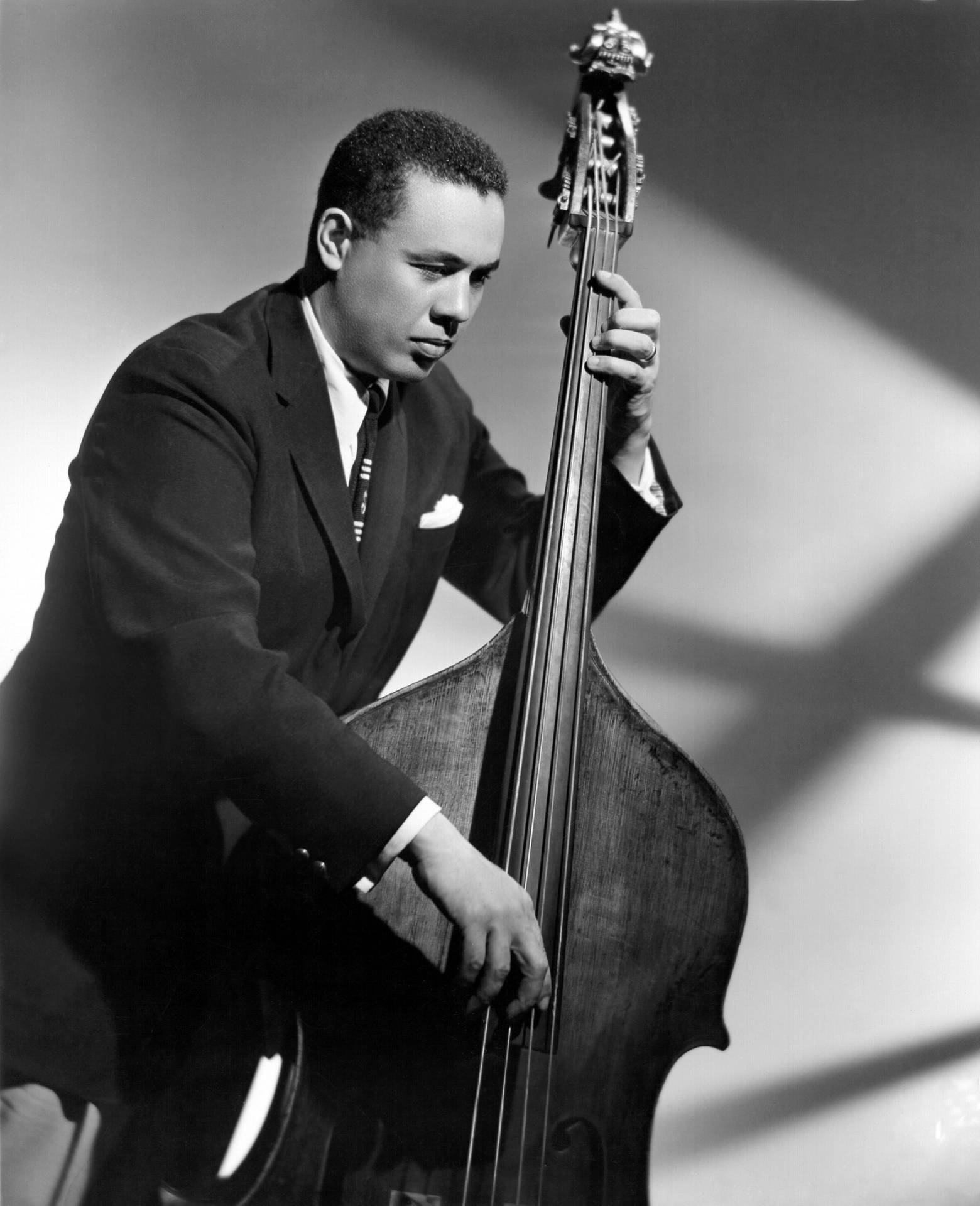 Caption: Charles Mingus, The Jazz Legend In Black And White Background