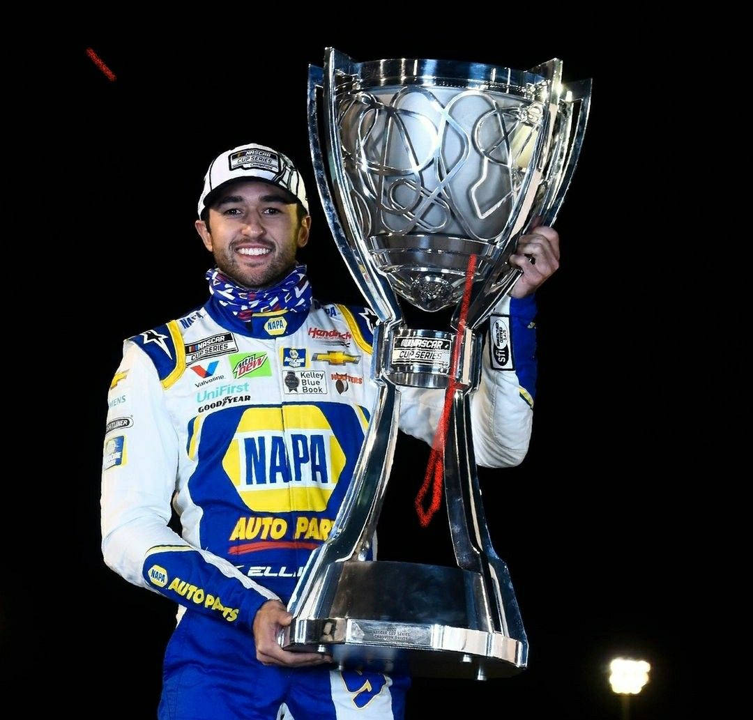 Caption: Chase Elliott Celebrates Victory With His Trophy Background