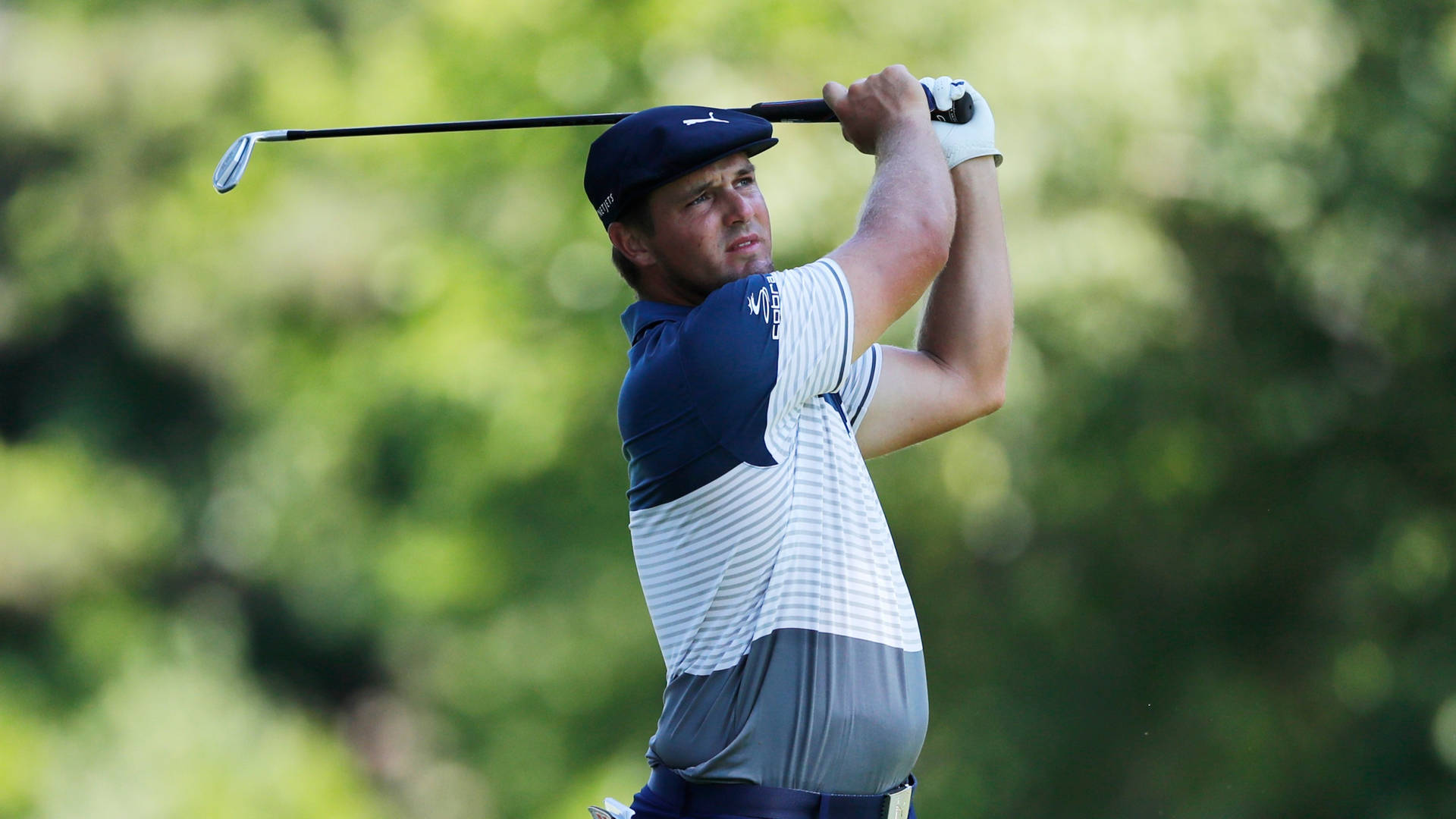 Caption: Chris Kirk Focused On Achieving The Perfect Swing During A Golf Match. Background