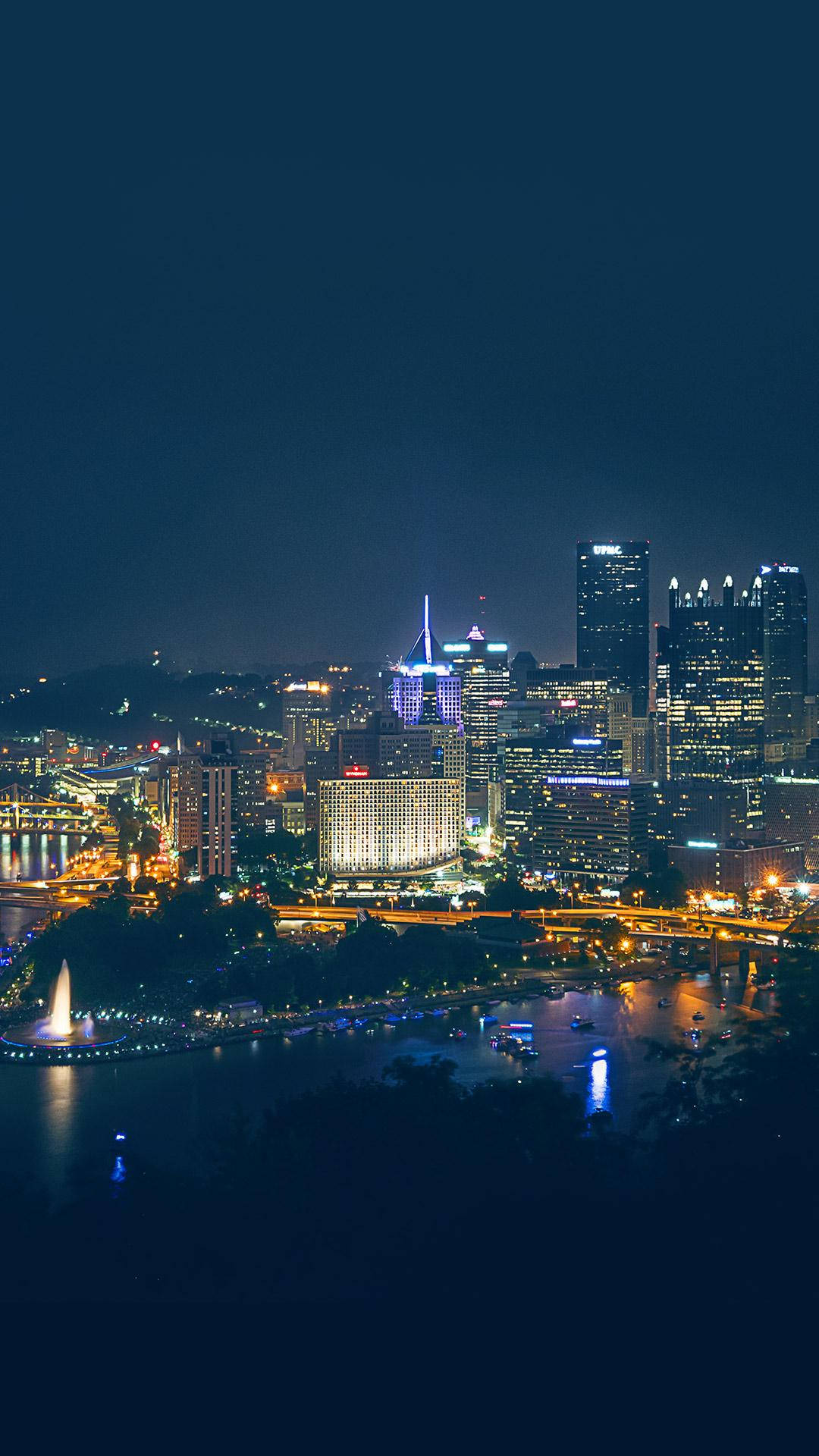 Caption: Cityscape Of Pittsburgh At Sunset Background