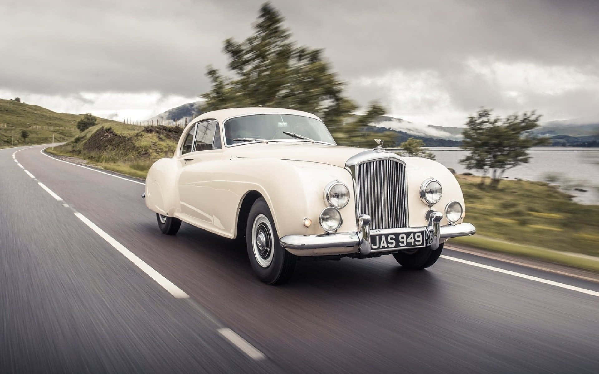 Caption: Classic Luxury Of The Past - Old Bentley Car Background