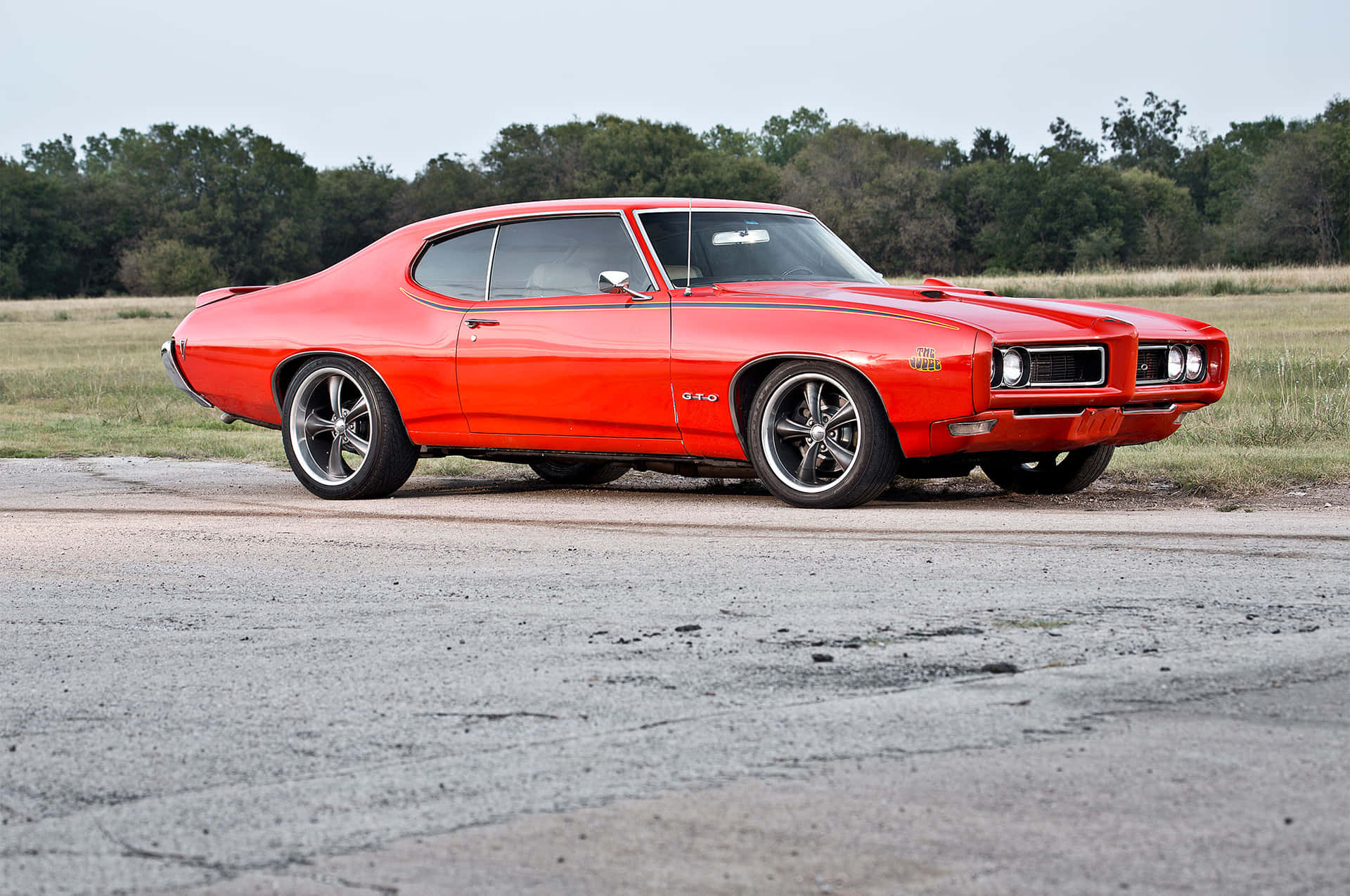 Caption: Classic Splendor: Pontiac Gto In Oceanic Blue Background