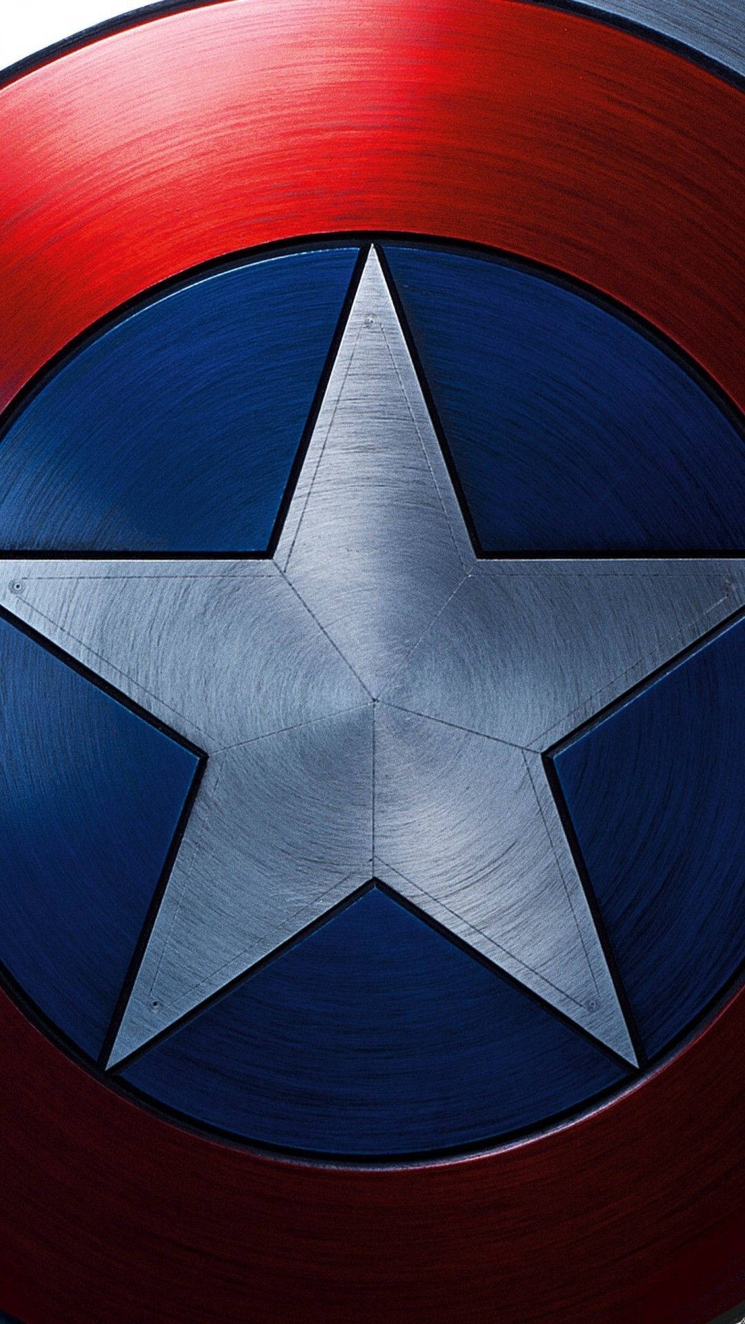 Caption: Close-up Of Captain America's Shield On An Iphone Screen Background