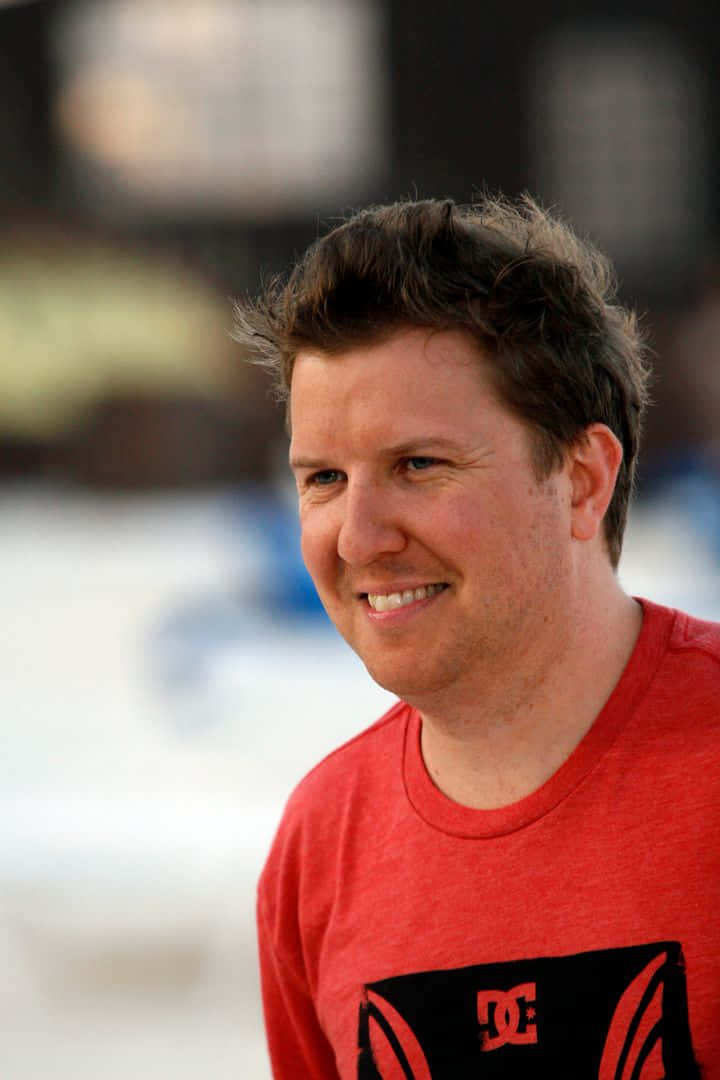 Caption: Comedian Nick Swardson Smiling Portrait Background
