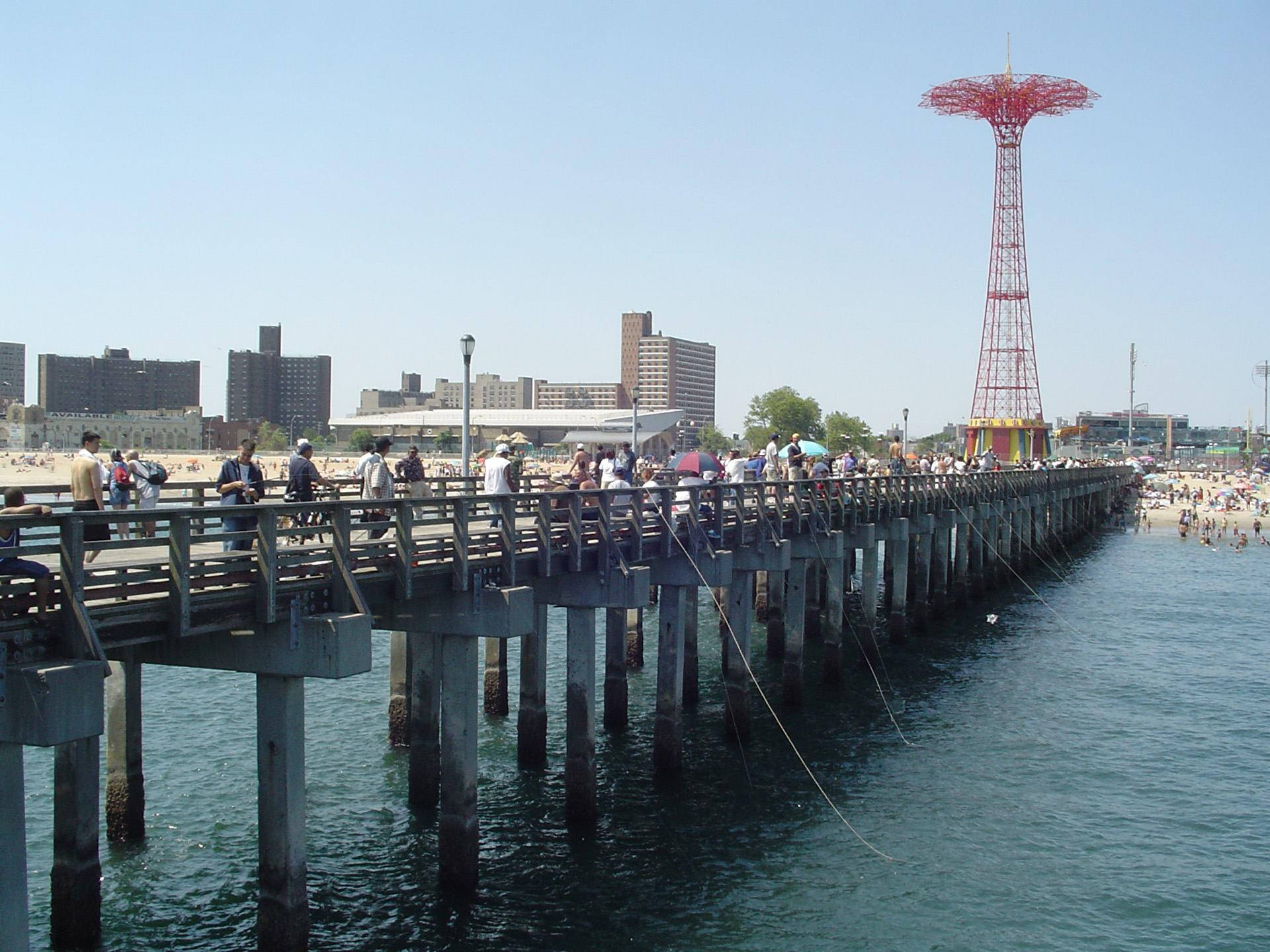 Caption: Coney Island's Iconic Parachute Pier Against A Sunset Sky