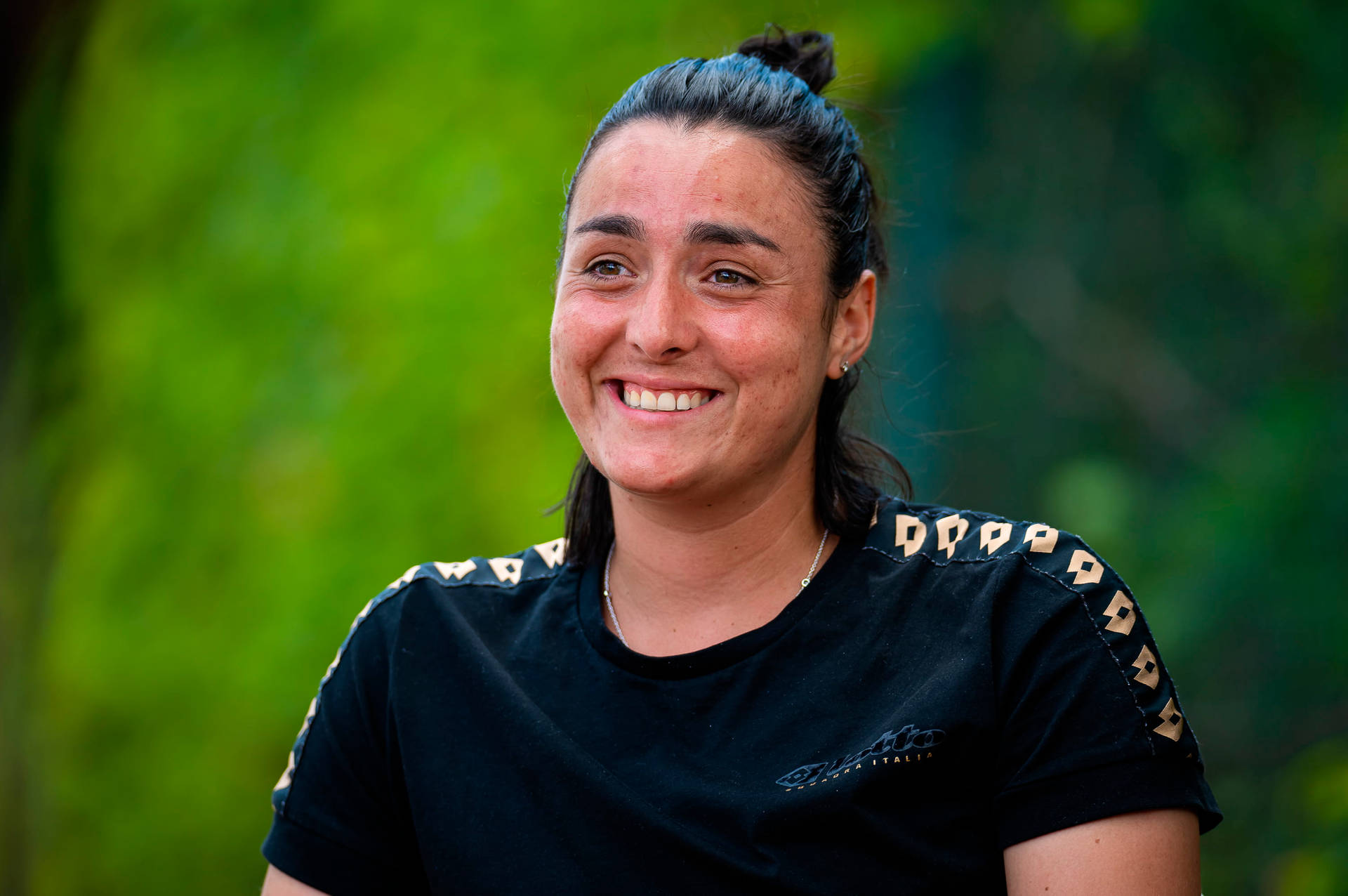 Caption: Confident Ons Jabeur Grinning In Black Top