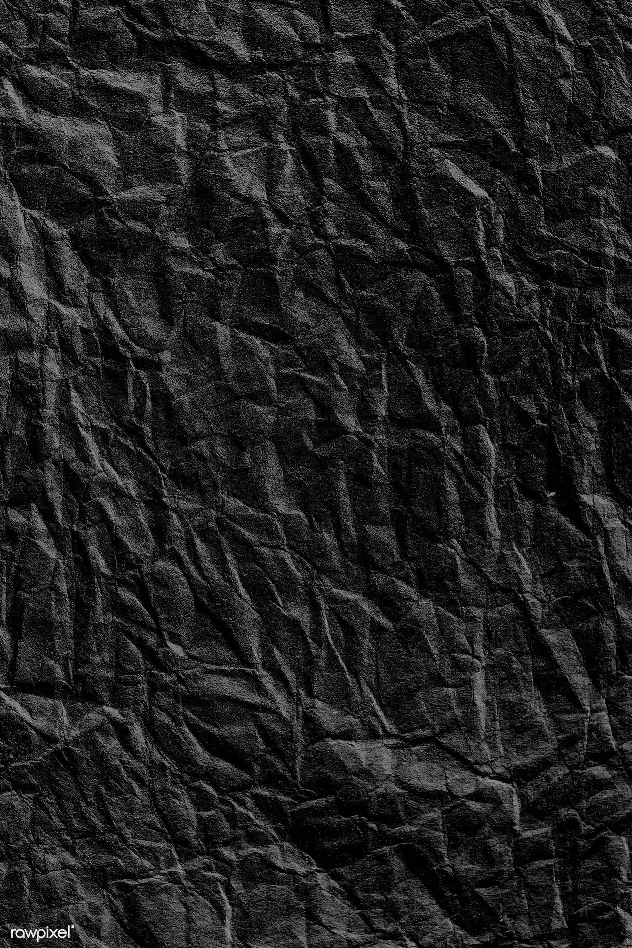 Caption: Dark Intricacy: A Crumpled Black Paper Texture Background