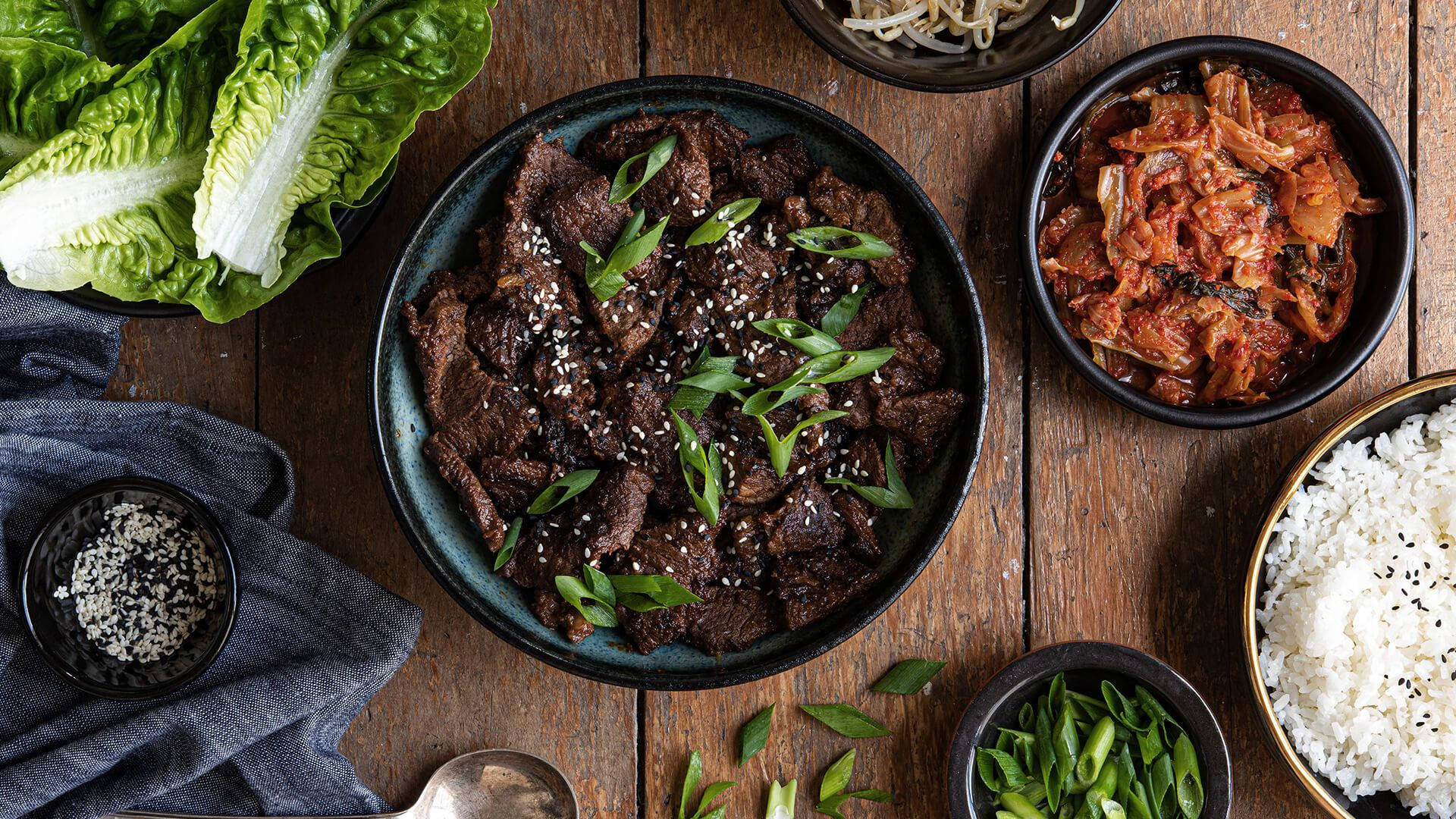 Caption: Delectable Bulgogi With A Sprinkle Of Sesame Seeds Background