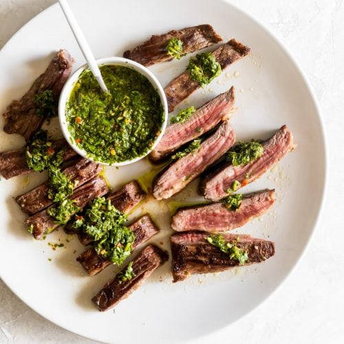 Caption: Delectable Churrasco With Chimichurri Sauce Background