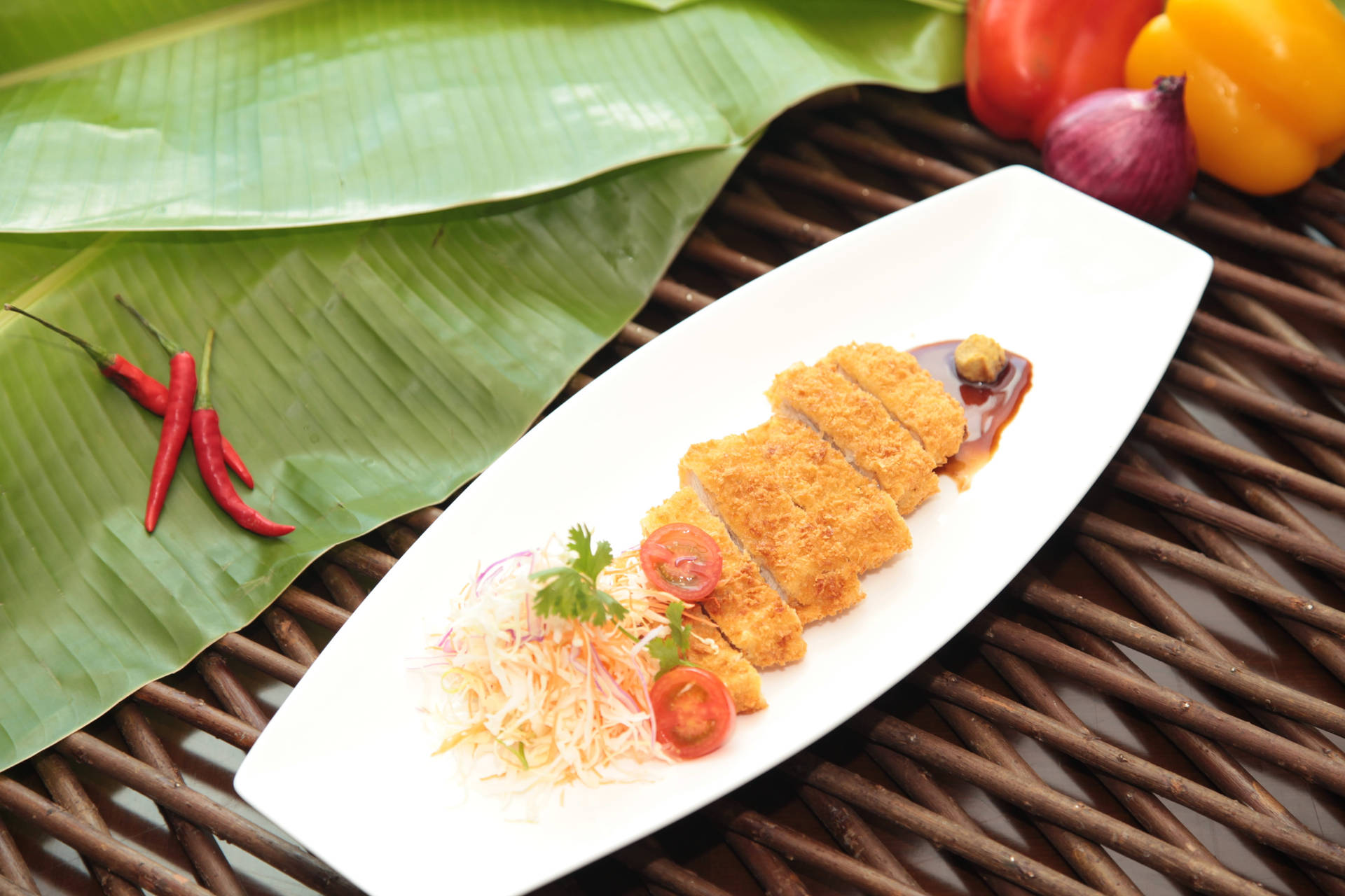 Caption: Delicious Tonkatsu On Banana Leaves Background