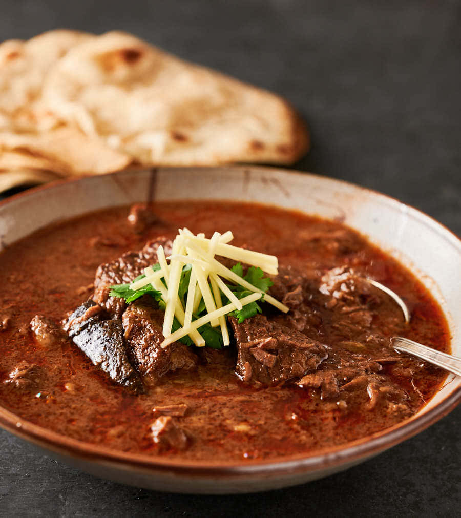Caption: Delightful Bowl Of Nihari - A Feast For The Eyes And Palate Background