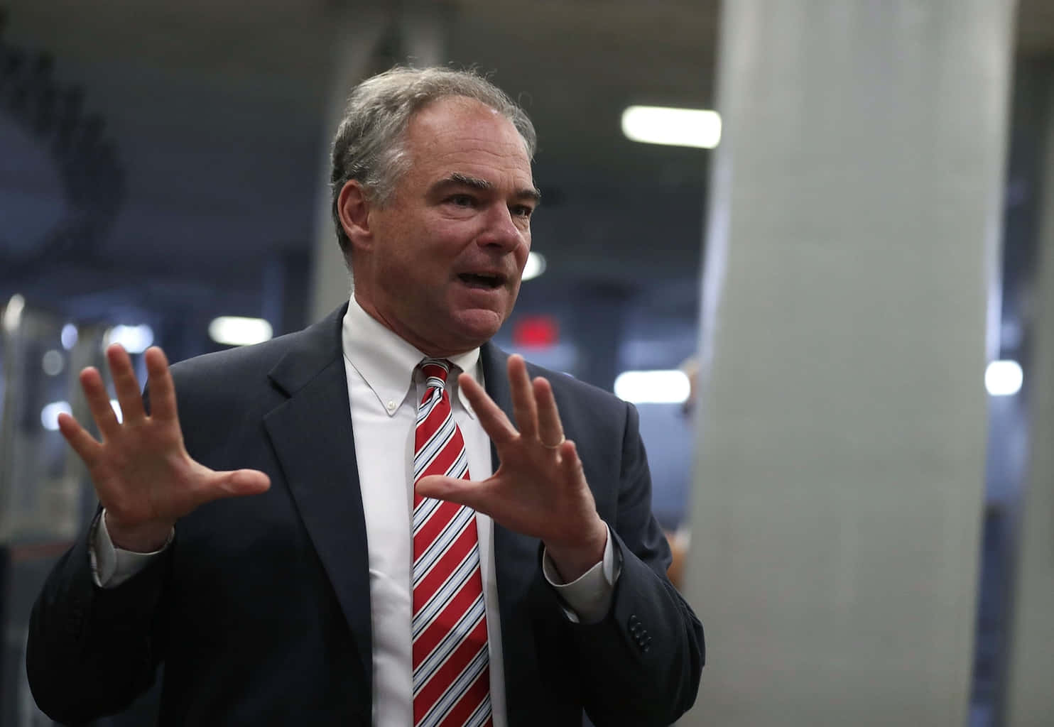 Caption: Democratic Senator Tim Kaine Passionately Addressing A Crowd Background
