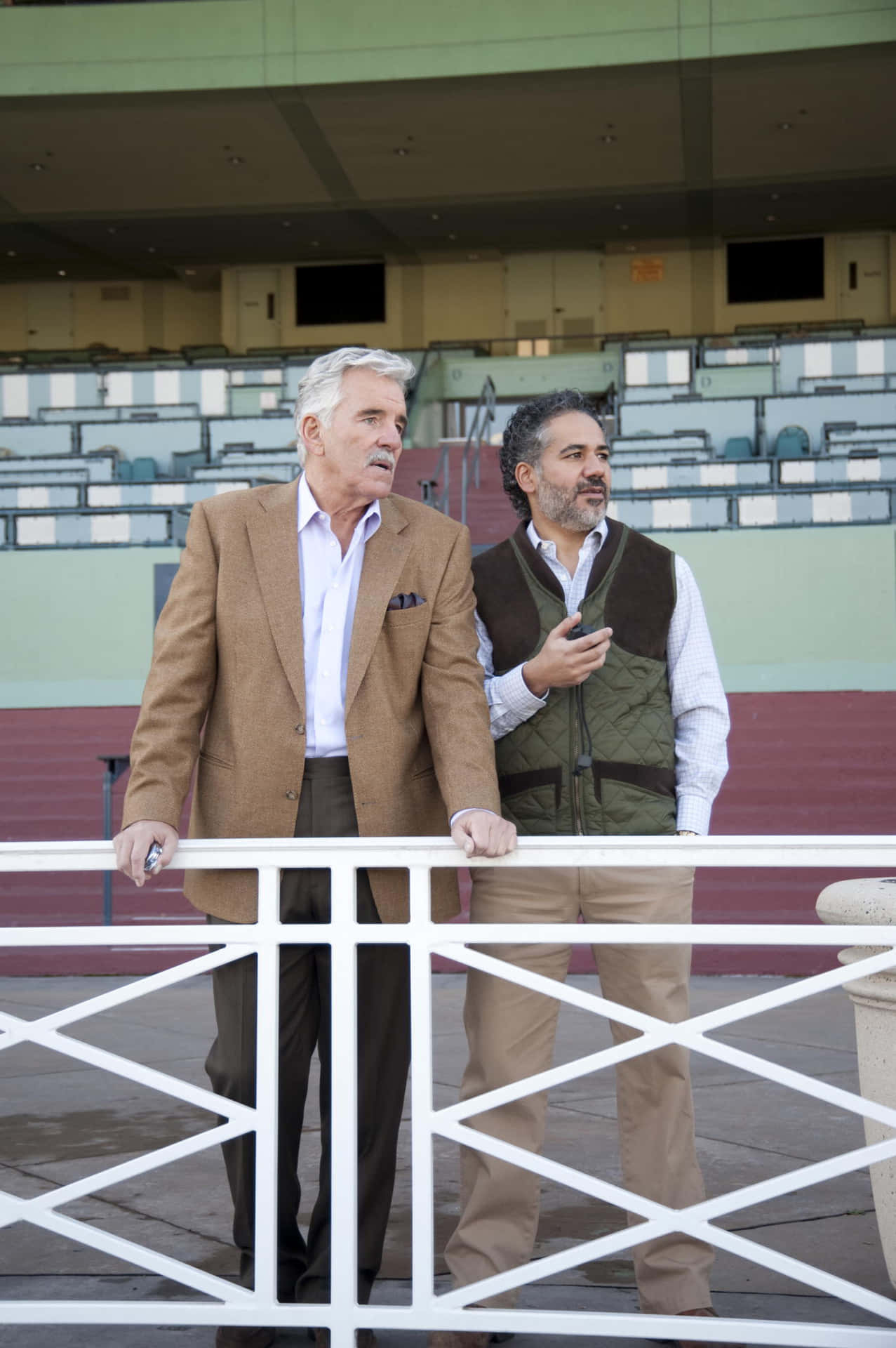 Caption: Dennis Farina Striking A Pose During A Photoshoot Background