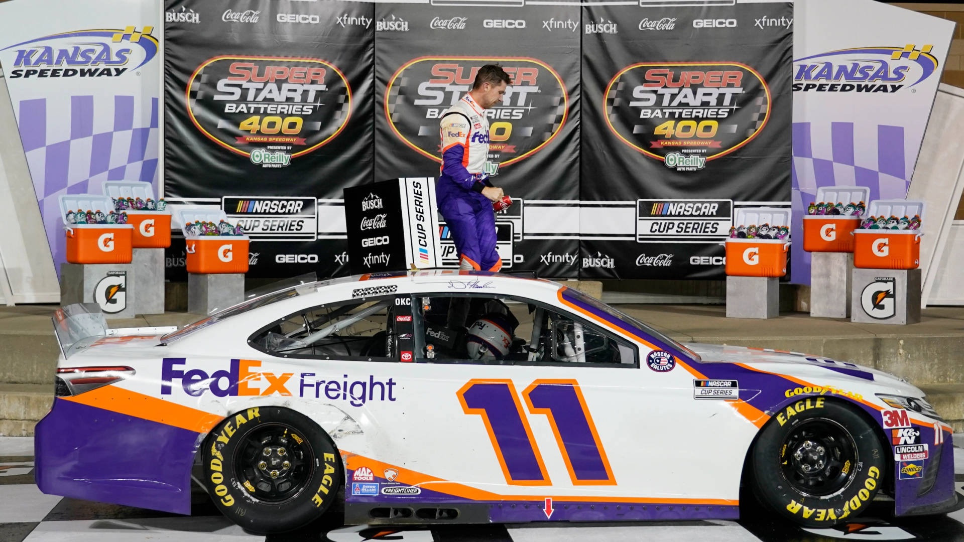 Caption: Denny Hamlin's Speed Demon On Display Background