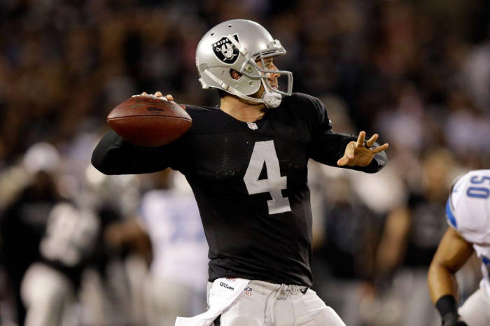 Caption: Derek Carr Brilliantly Executing A Play On The Field. Background