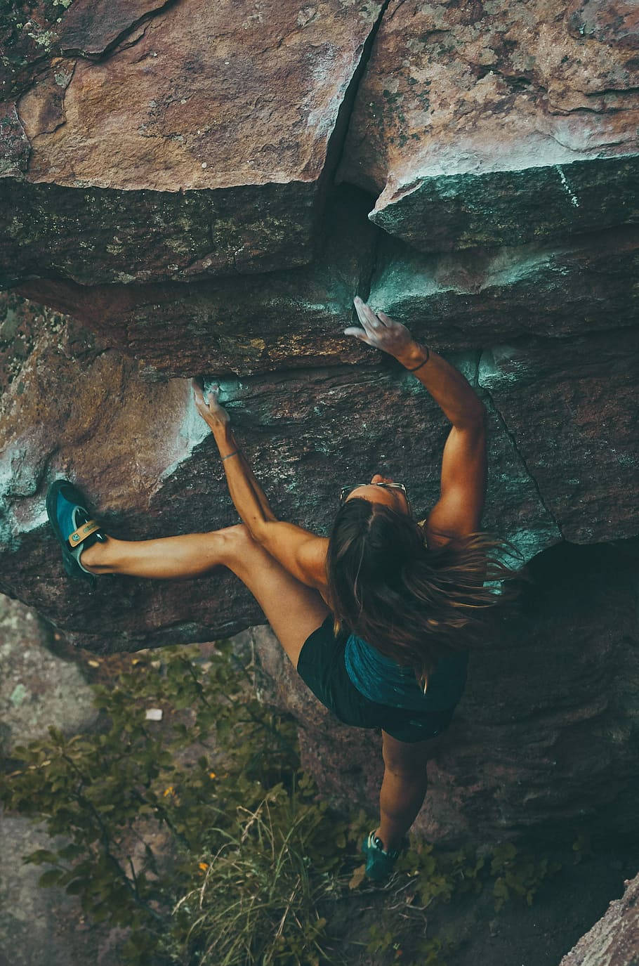 Caption: Determined Female Climber Conquers Mountain Summit Background