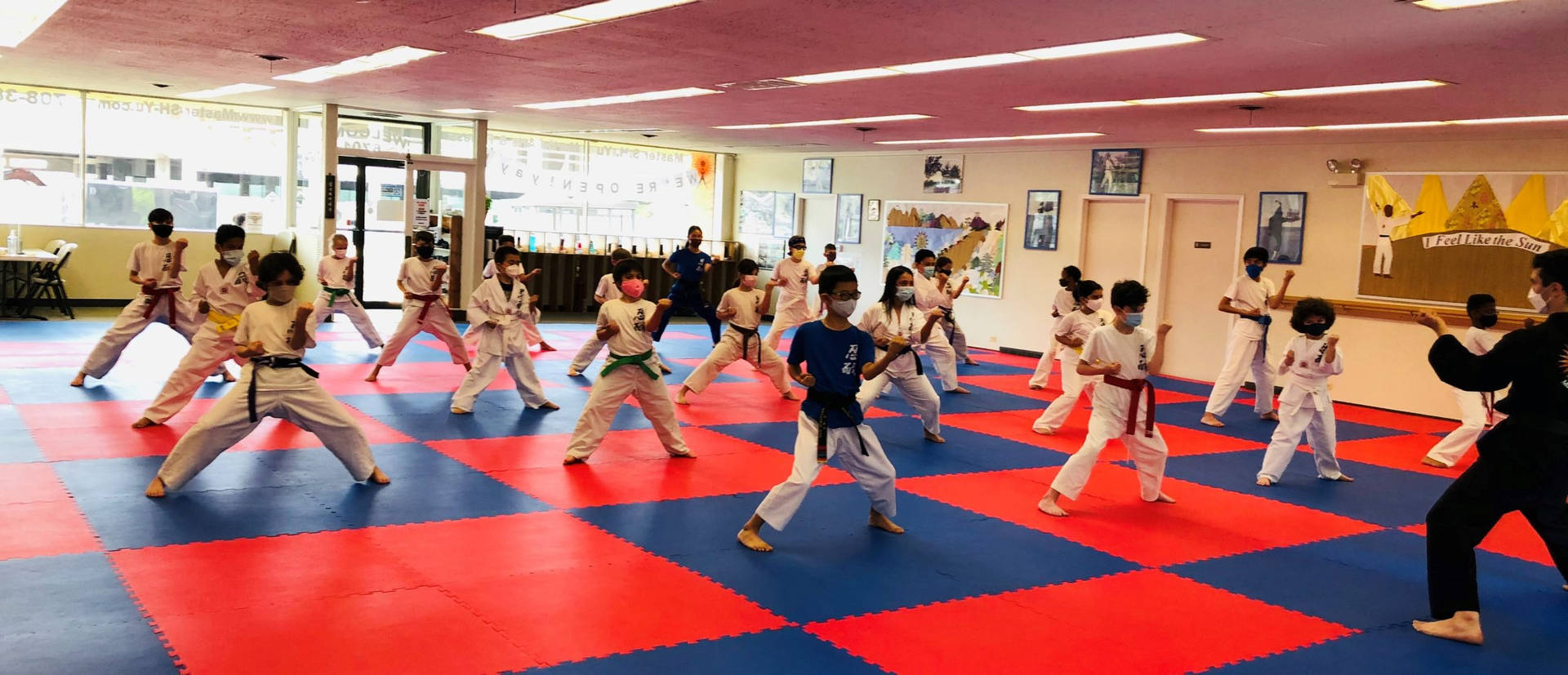 Caption: Diligent Young Karate Students Training In A Traditional Dojo