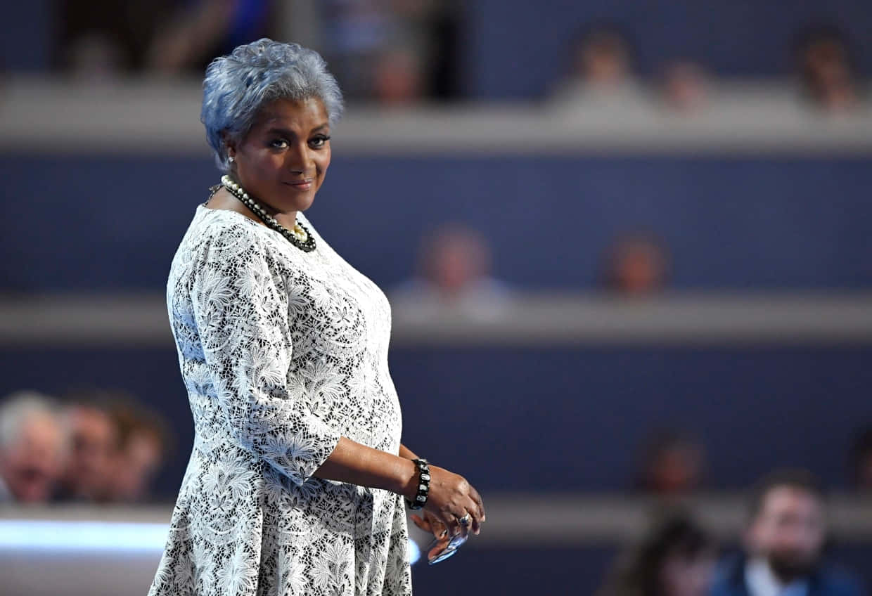 Caption: Donna Brazile Delivering A Thoughtful Speech Background