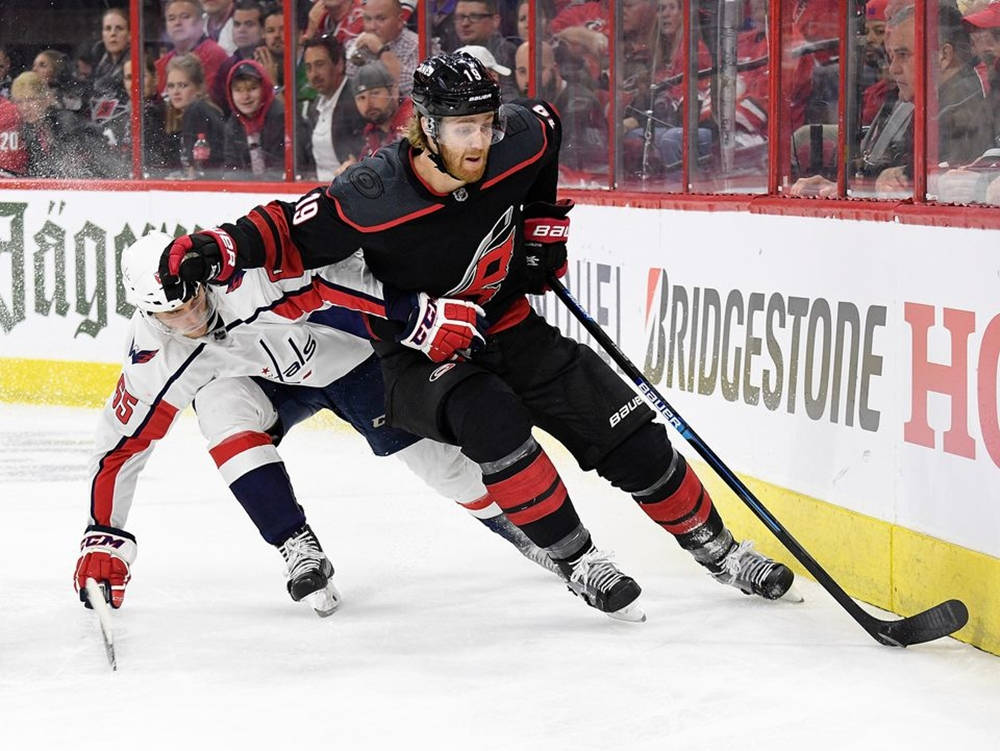 Caption: Dougie Hamilton In Action Against Andre Burakovsky Background