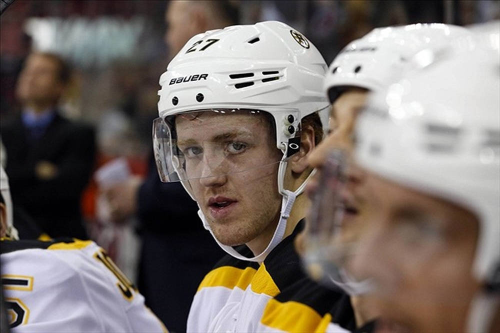 Caption: Dougie Hamilton Ready For Action In Boston Bruins Bench Background