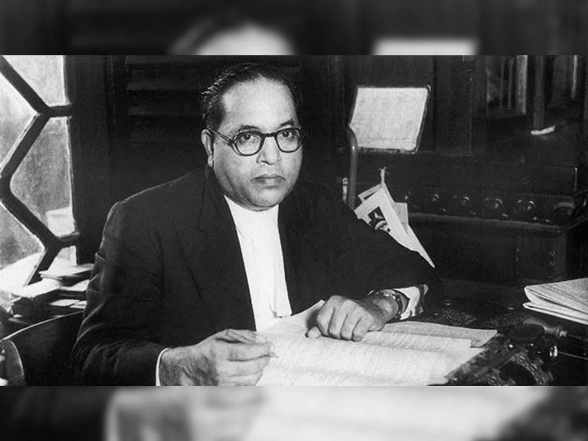 Caption: Dr. Babasaheb Ambedkar Engrossed In Books Background