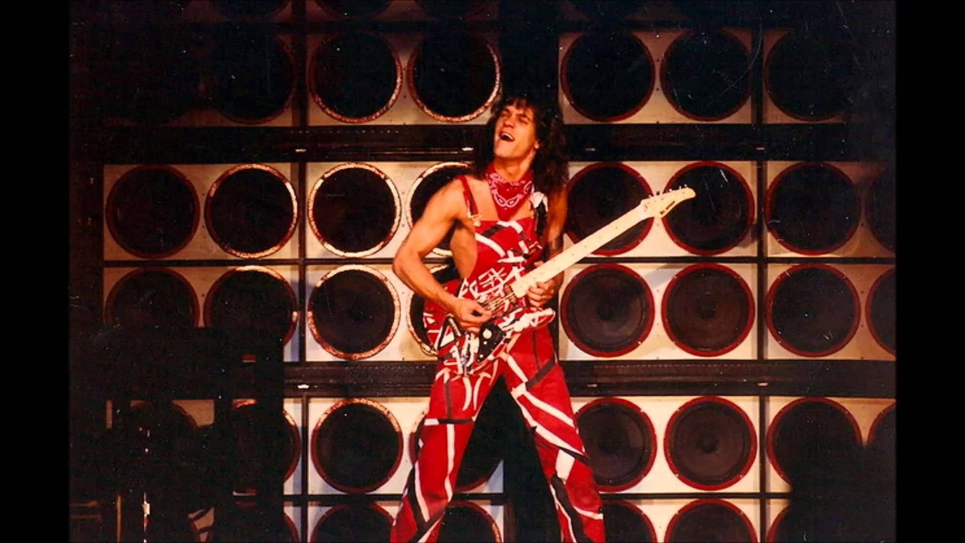 Caption: Eddie Van Halen Rocking On Stage Background
