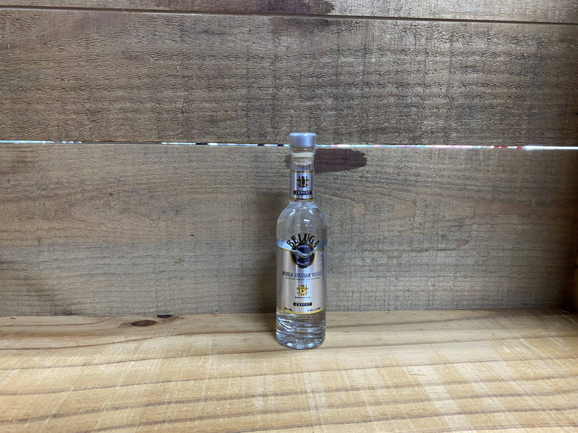 Caption: Elegant Beluga Vodka Bottle On Classic Wood Floor