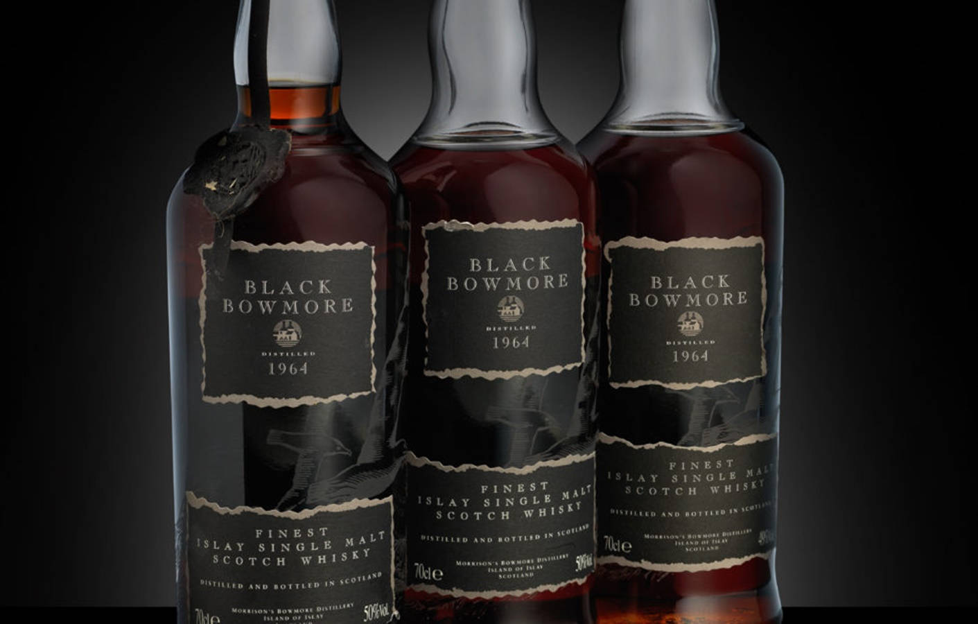 Caption: Elegant Black Bowmore Whisky Bottles On Display Background