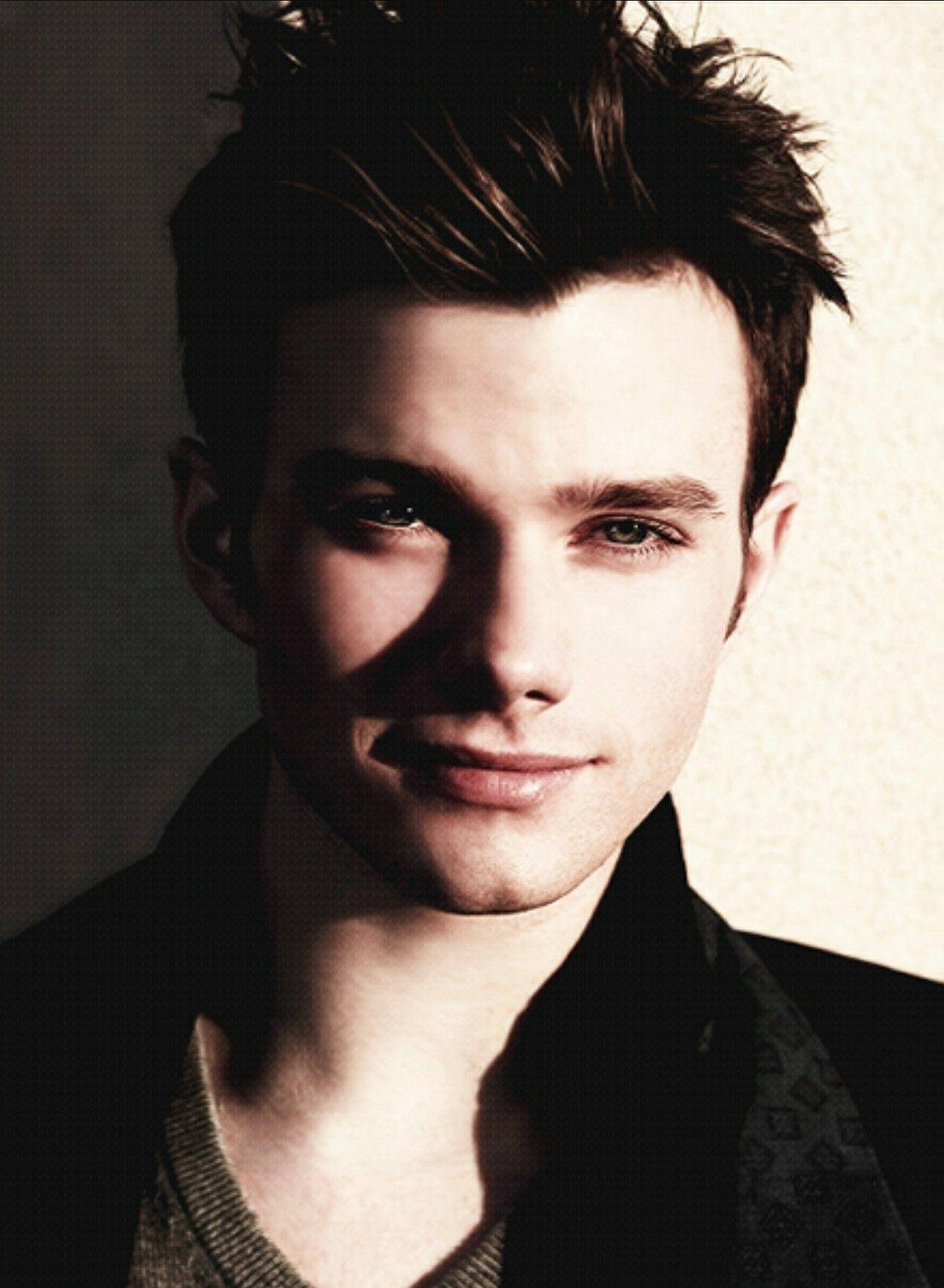 Caption: Elegant Chris Colfer Posing In A Handsome Photoshoot Background