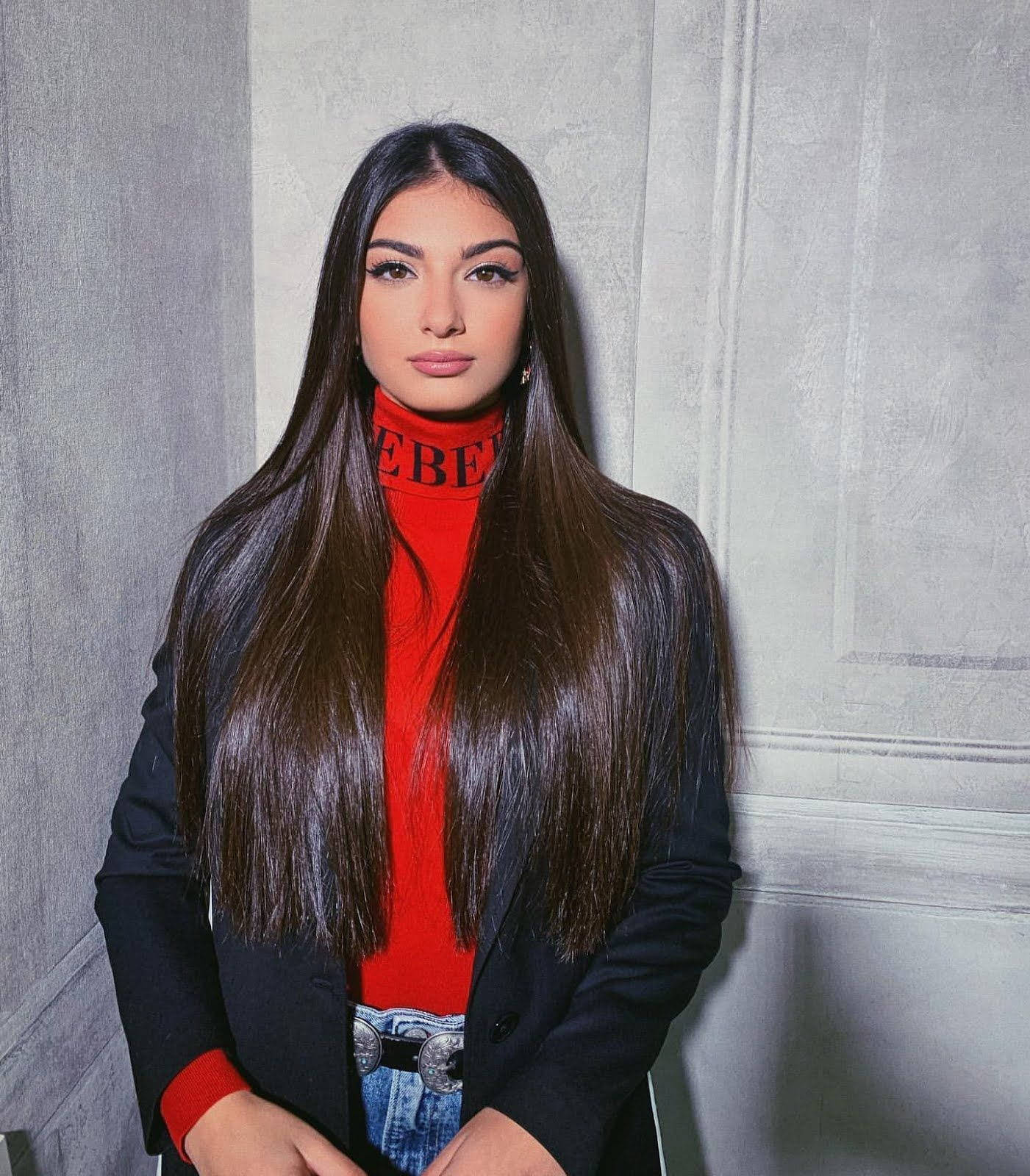 Caption: Elegant Italian Girl In Red Turtleneck Background