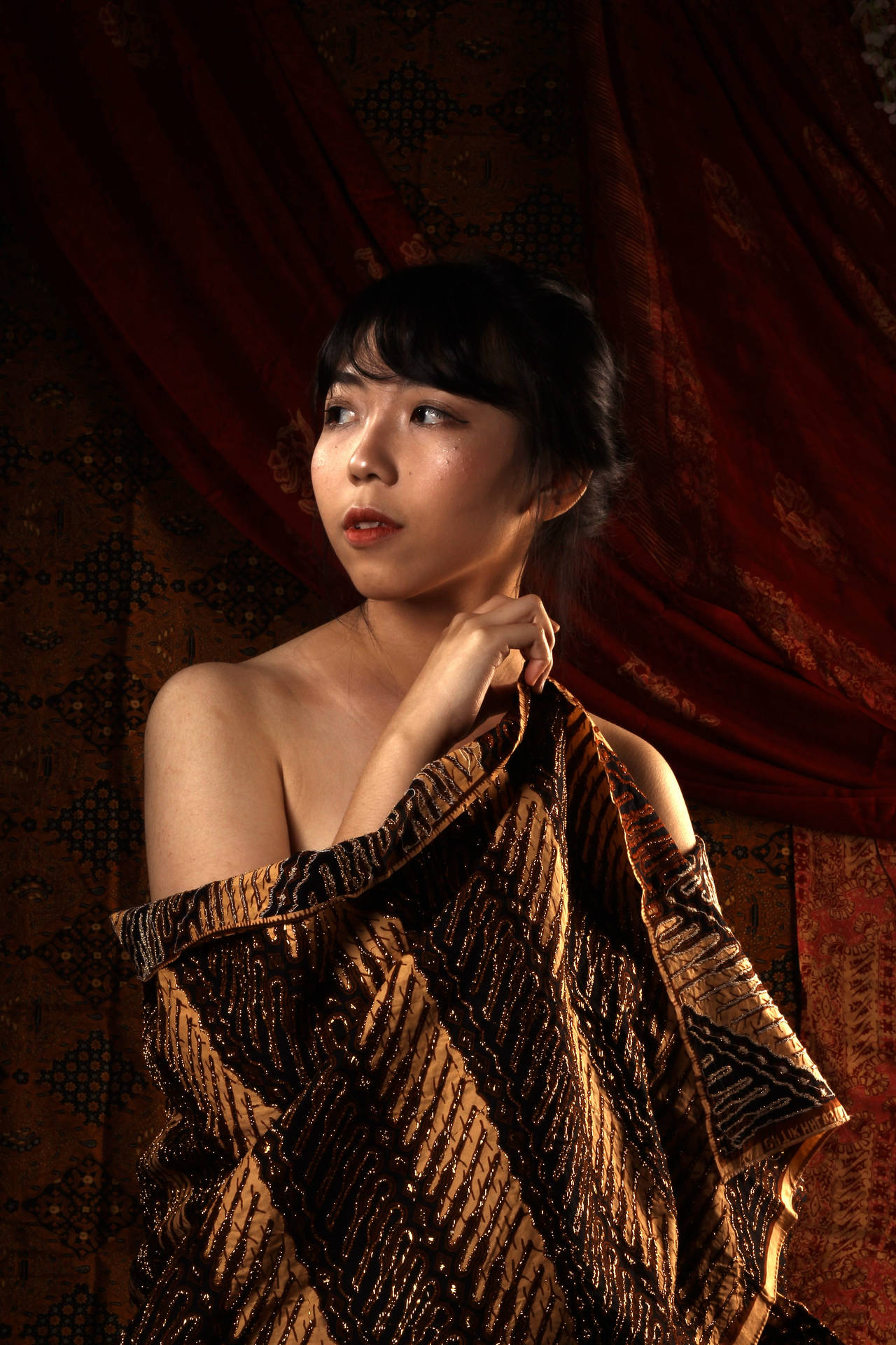 Caption: Elegant Woman In Traditional Batik Blouse Background