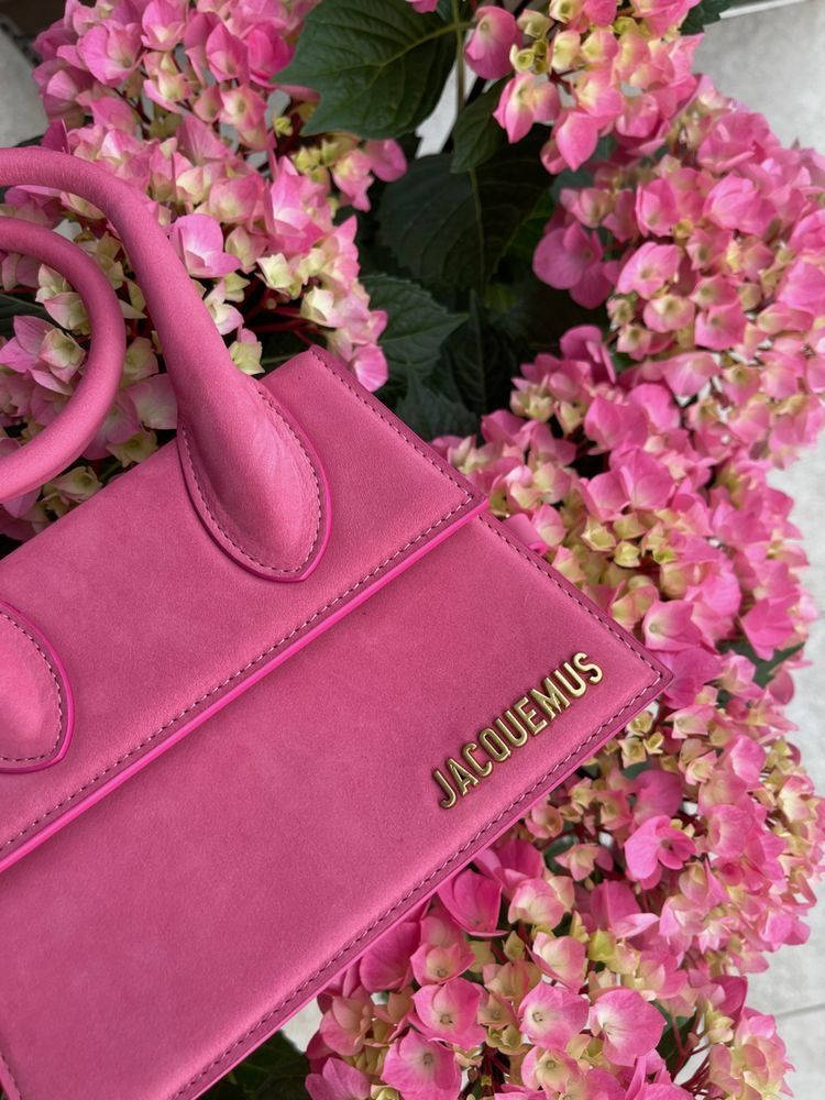 Caption: Embrace Luxury With The Pink Jacquemus Handbag. Background