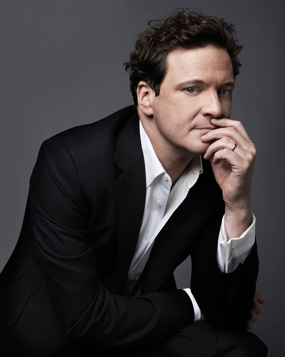 Caption: English Actor Colin Firth In A Classy Portrait Background