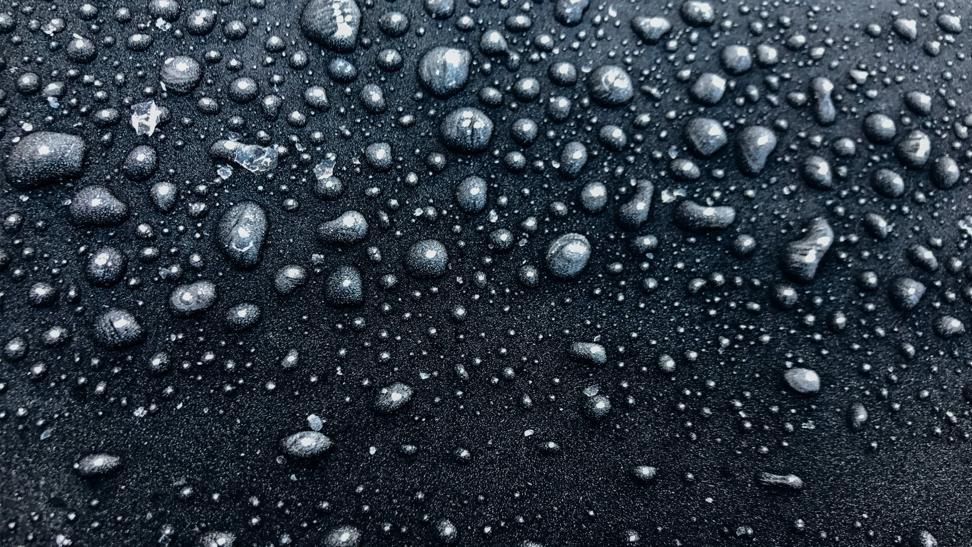 Caption: Enigmatic 4d Ultra Hd Close-up Of Matte Black Raindrops