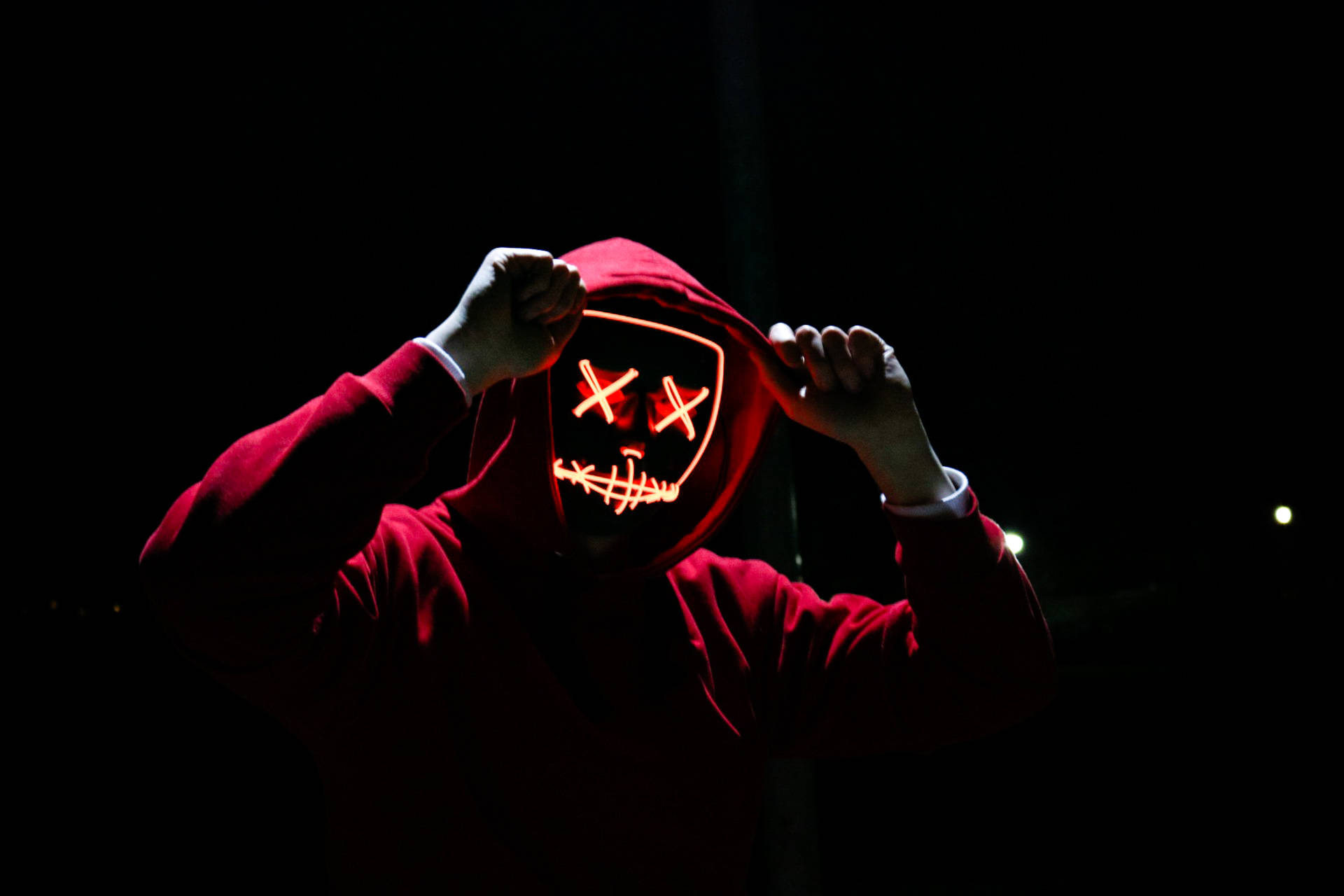 Caption: Enigmatic Figure In Dark Red Hoodie Background