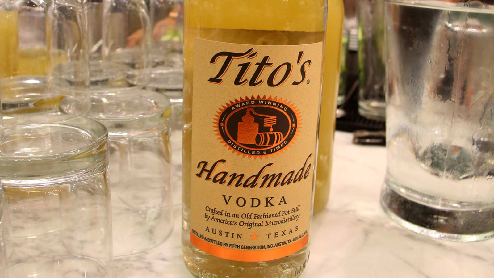 Caption: Exceptional Quality, Tito's Handmade Vodka Bottle Background