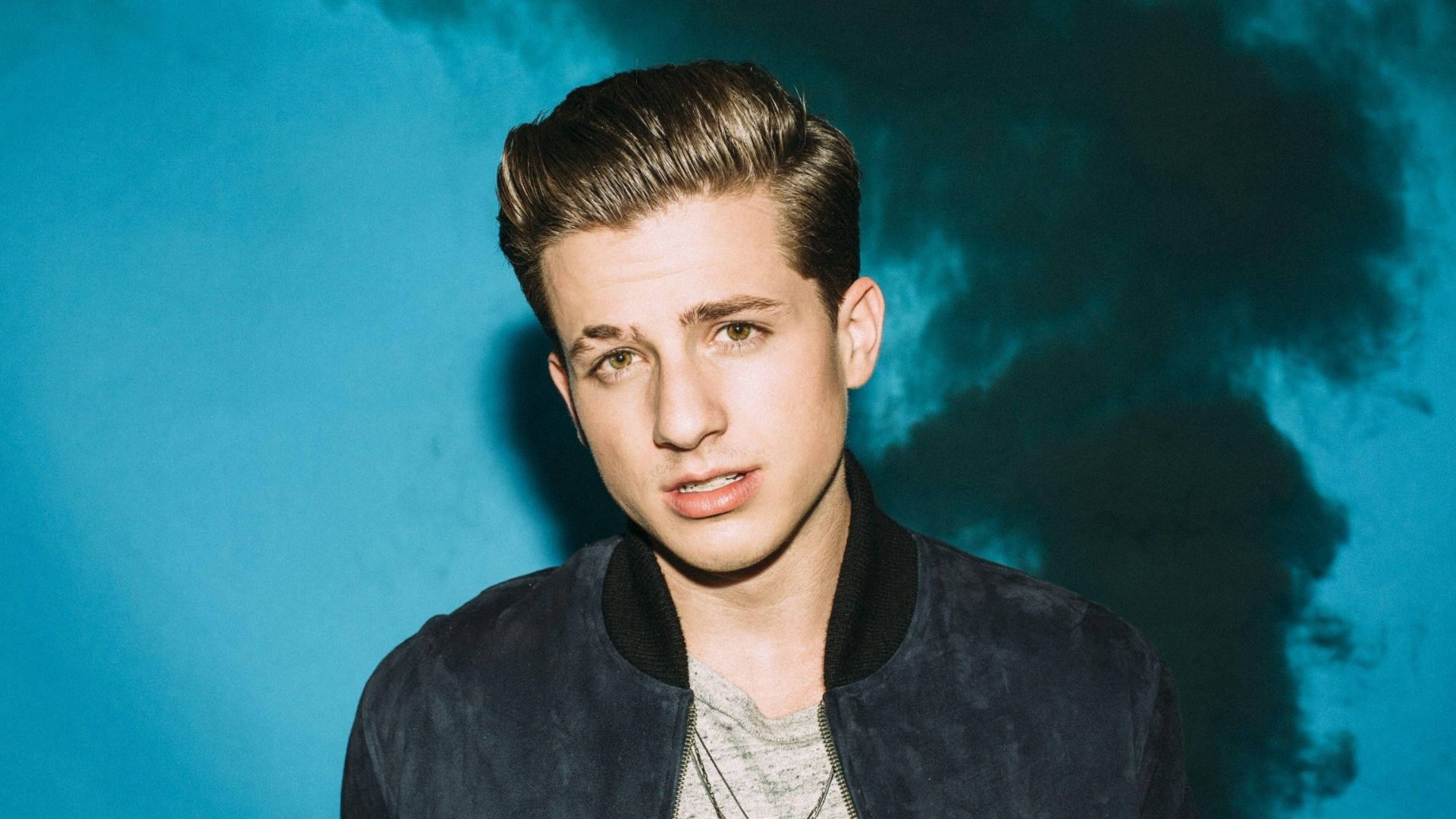Caption: Exceptional Talent, Charlie Puth In A Misty Backdrop Background