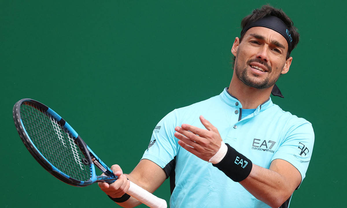 Caption: Fabio Fognini In Action On The Green Backdrop Background