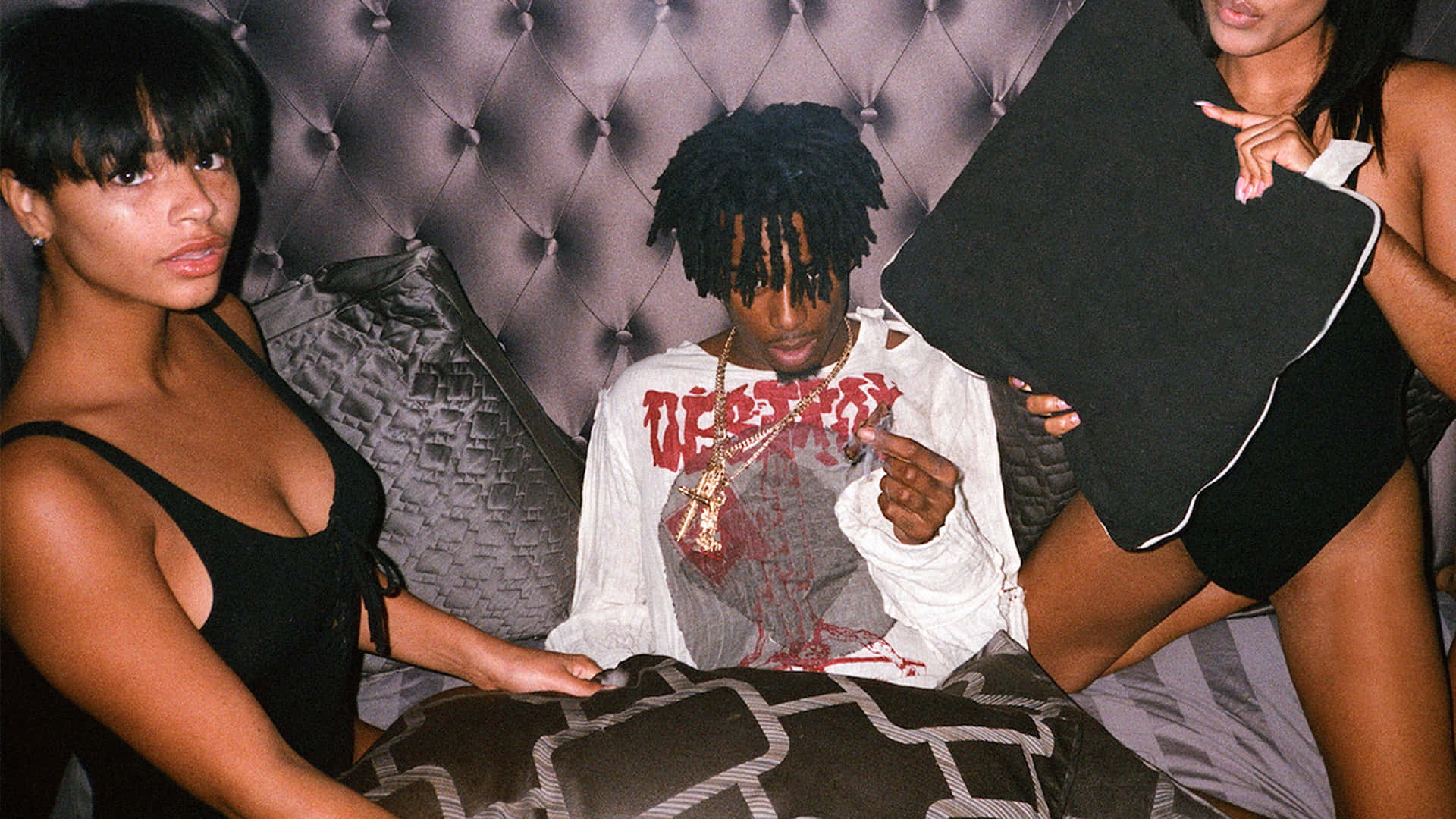 Caption: Fashion-forward Carti Pfp Sprawled On A Cozy Bed Background