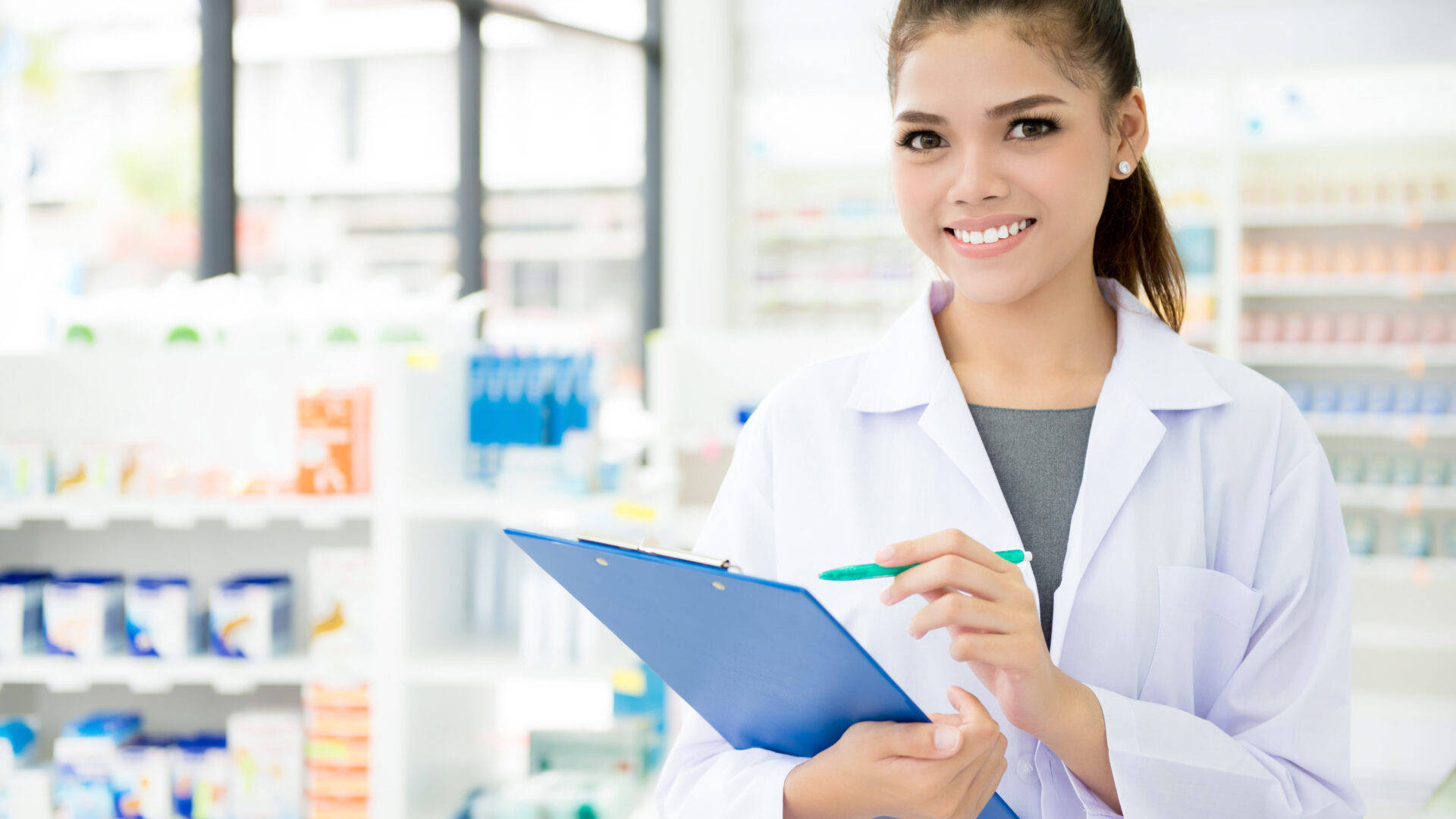 Caption: Female Pharmacist Analyzing Patients' Records Background