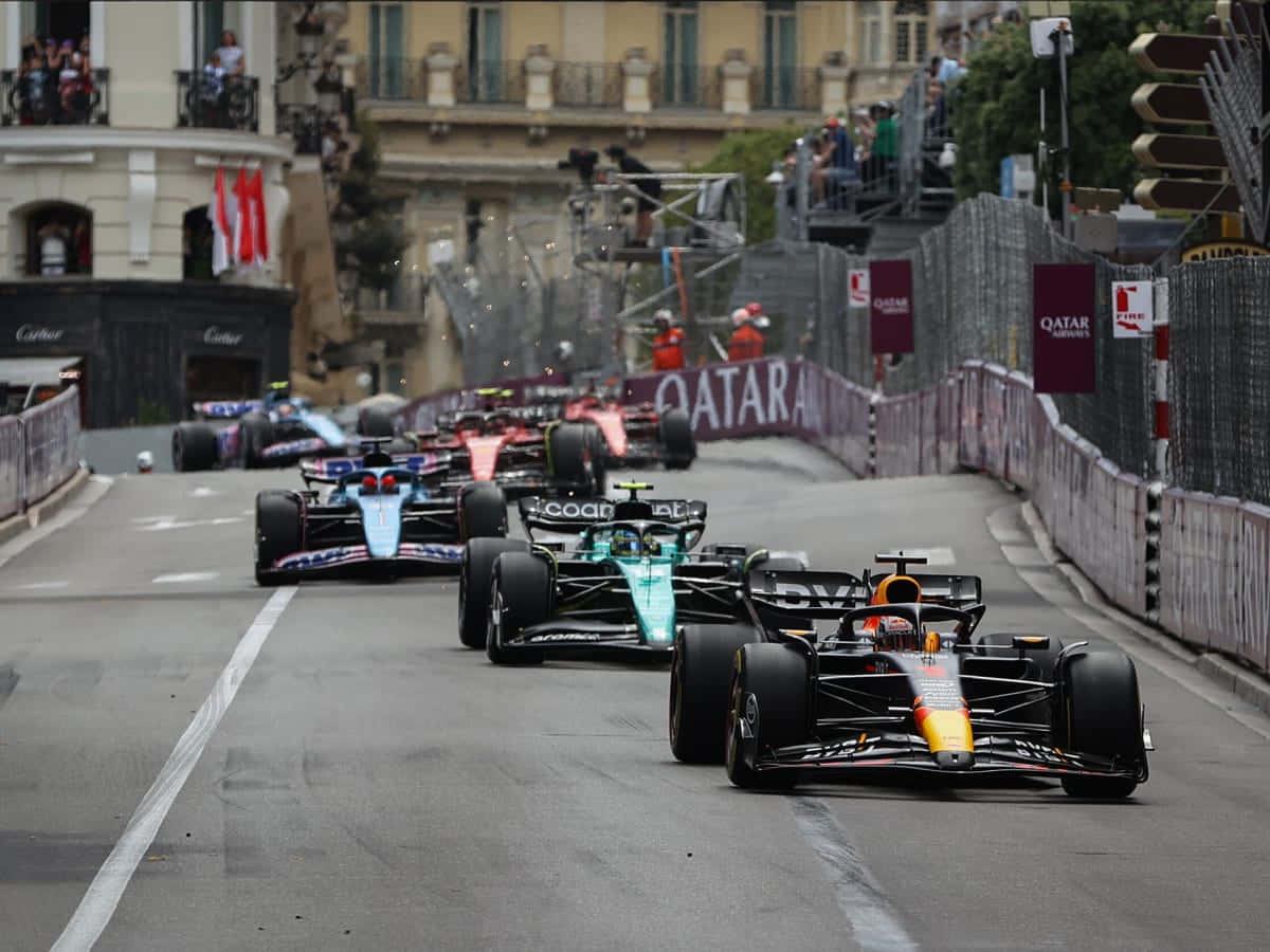Caption: Formula 1 Race - High Adrenaline Action Background