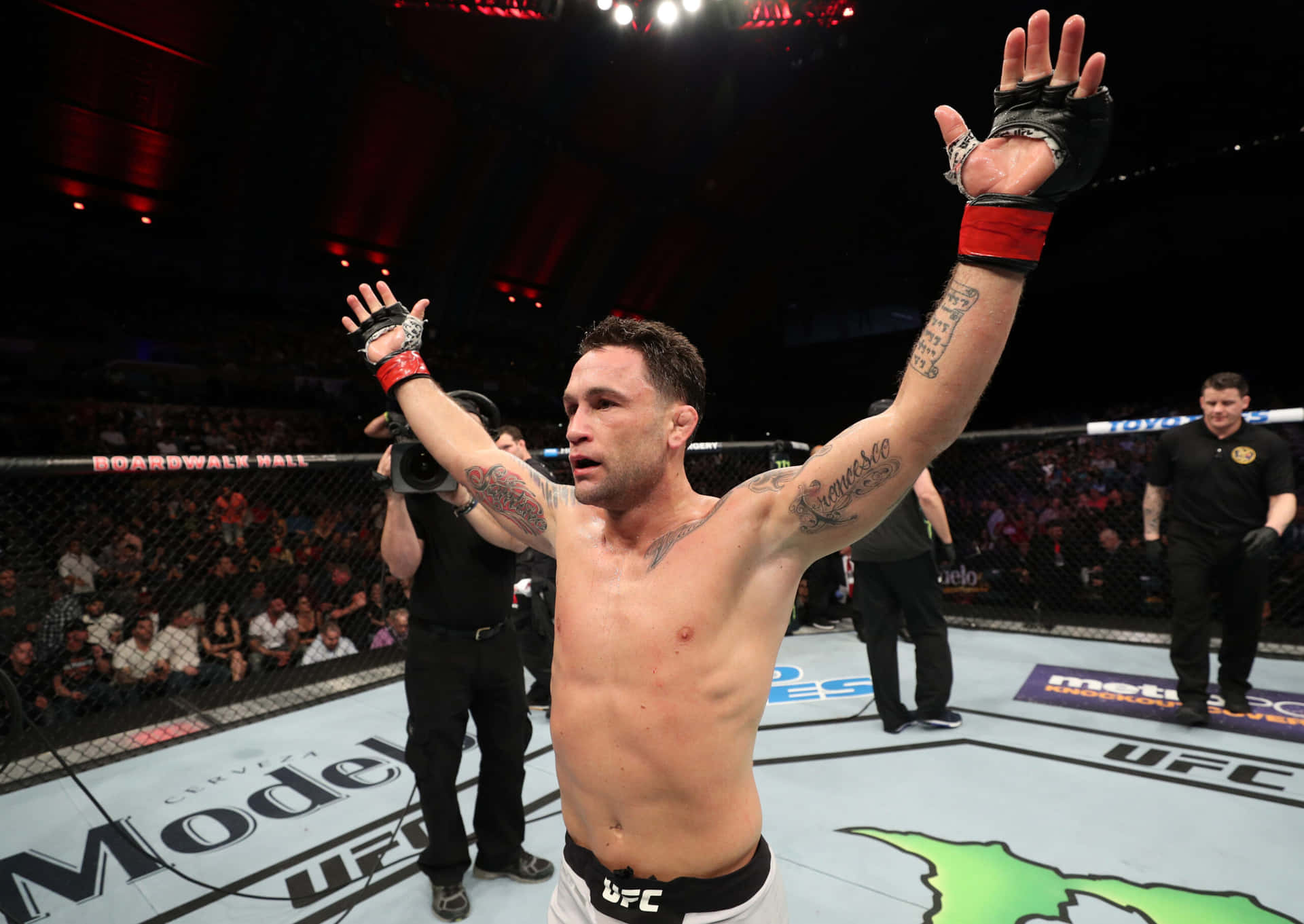 Caption: Frankie Edgar Delivering A Winning Strike Against Cub Swanson Background