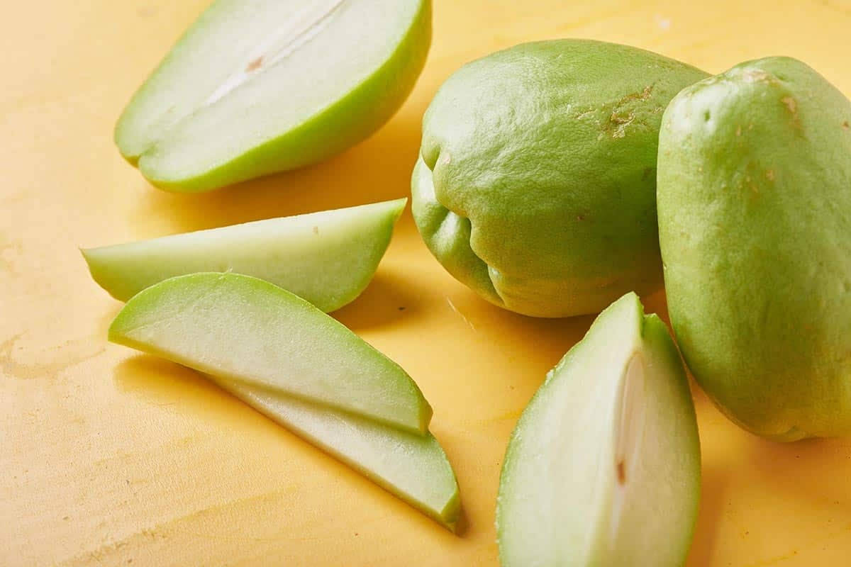 Caption: Fresh And Healthy Sliced Chayote Background